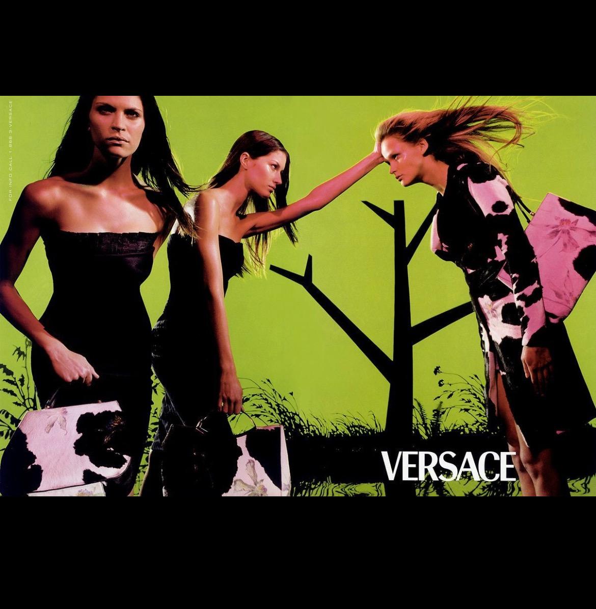 TheRealList presents: a fabulous pony-hair cow print Gianni Versace tote with hand-painted purple flowers, designed by Donatella Versace. From the Spring/Summer 1999 collection, this bag was highlighted in the season's ad campaign photographed by