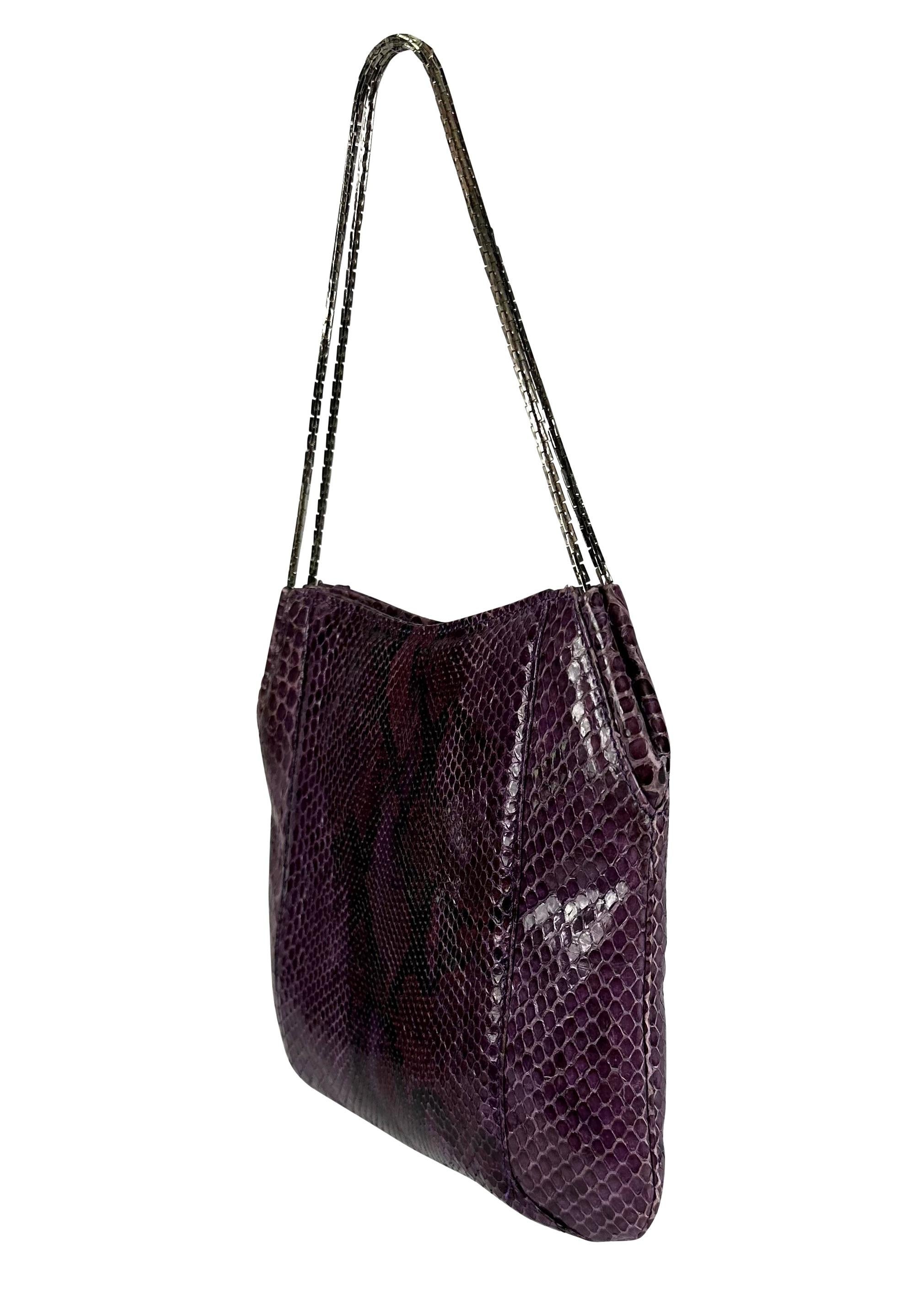 Presenting an incredible purple python Gianni Versace mini bag, designed by Donatella Versace. From the Fall/Winter 1999 collection, this bag is constructed of purple python and is made complete with a silver-tone chain handle. 

Approximate