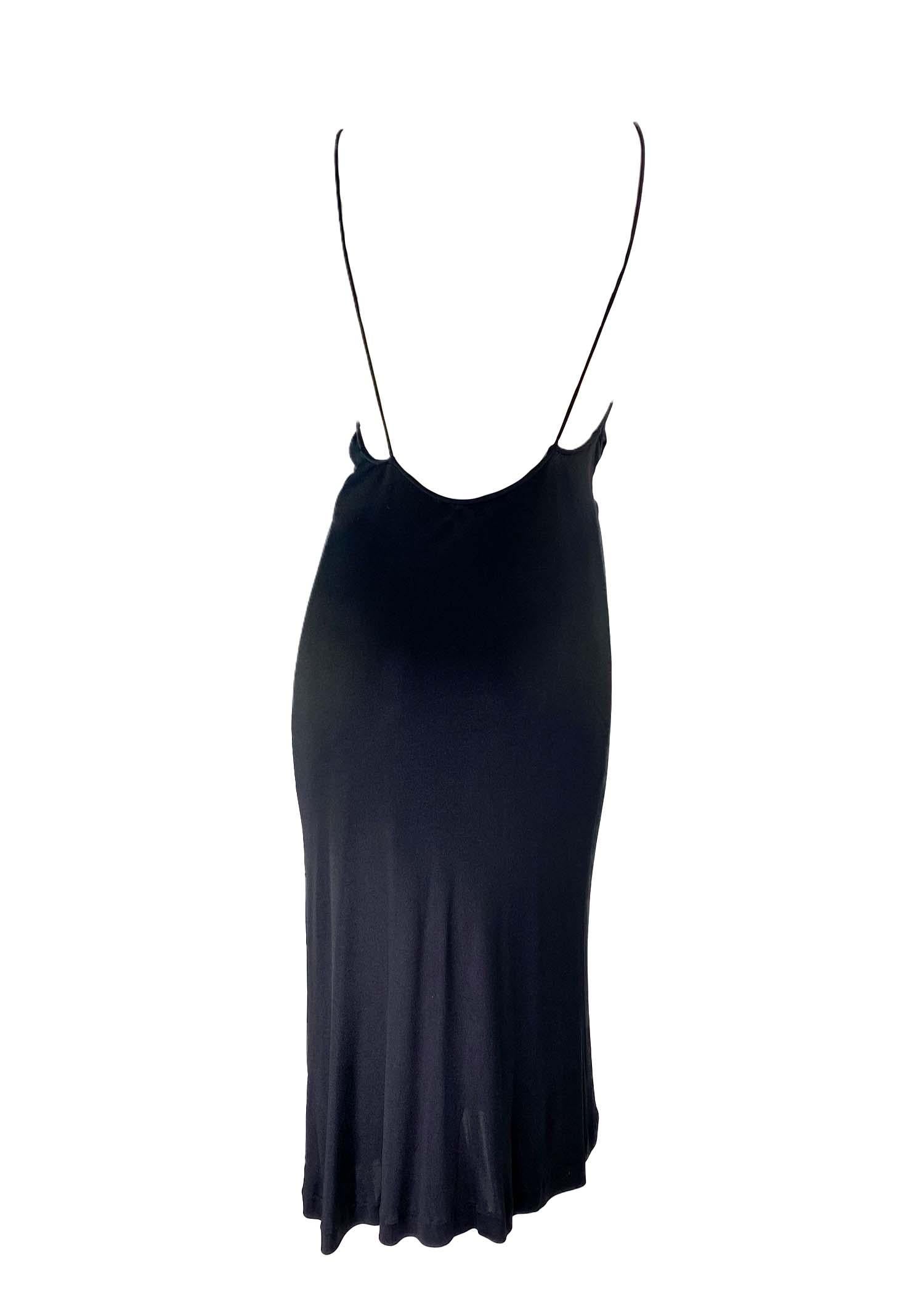 Presenting a gorgeous backless viscose Gucci dress with a patent leather trim, designed by Tom Ford for Gucci's Fall/Winter 1999 collection. This Midi dress is ruched around the front facing patent leather accent which draws the neckline in to