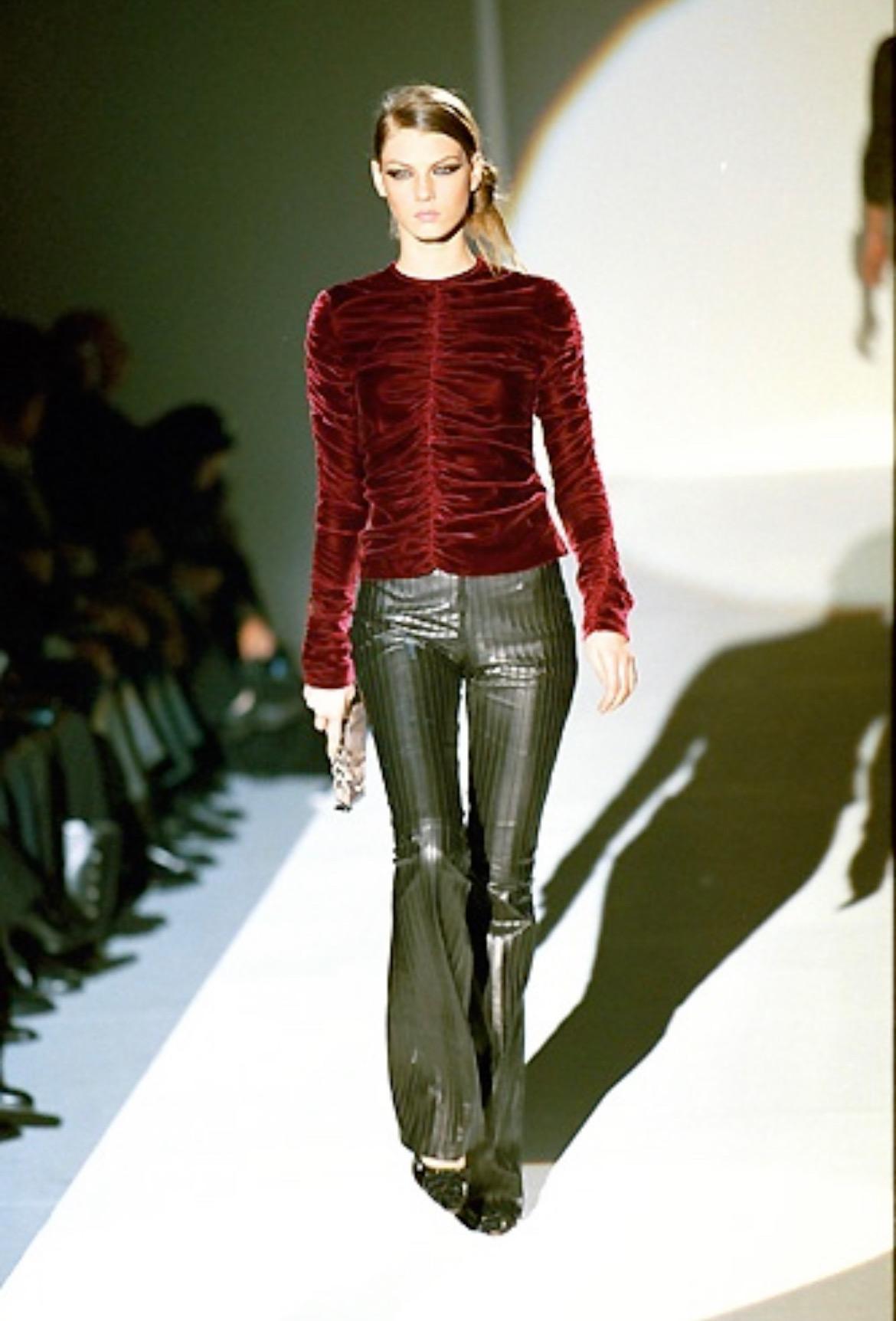 Presenting a gorgeous ruched deep red velvet Gucci top, designed by Tom Ford. From the Fall/Winter 1999 collection, this fabulous top debuted on the season's runway. Completely covered in ruching, this top features long sleeves and a crew neckline.