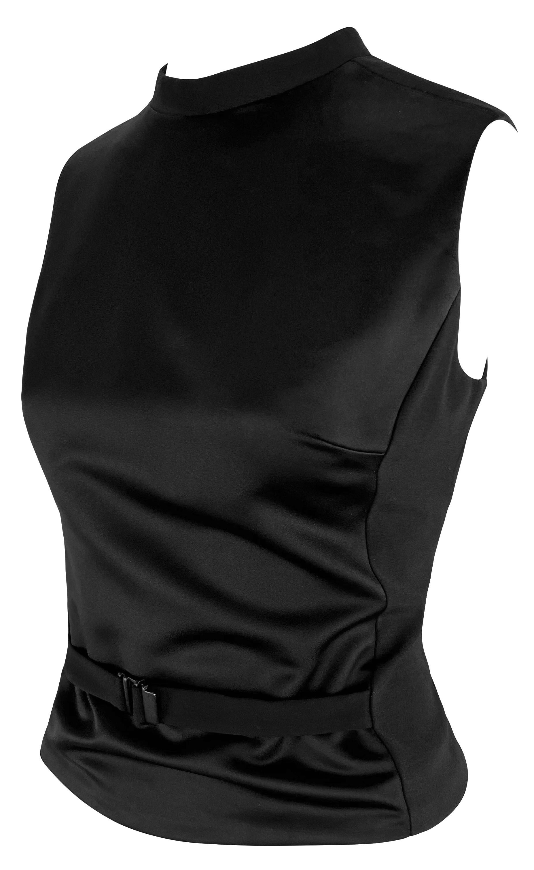 This sleek Tom Ford-designed twist on the classic Gucci sweater vest features a satin front panel with a buckle for a cinched waist and a zippered back. Created for the Fall/Winter 1999 collection, this vest is the perfect chic elevation of a