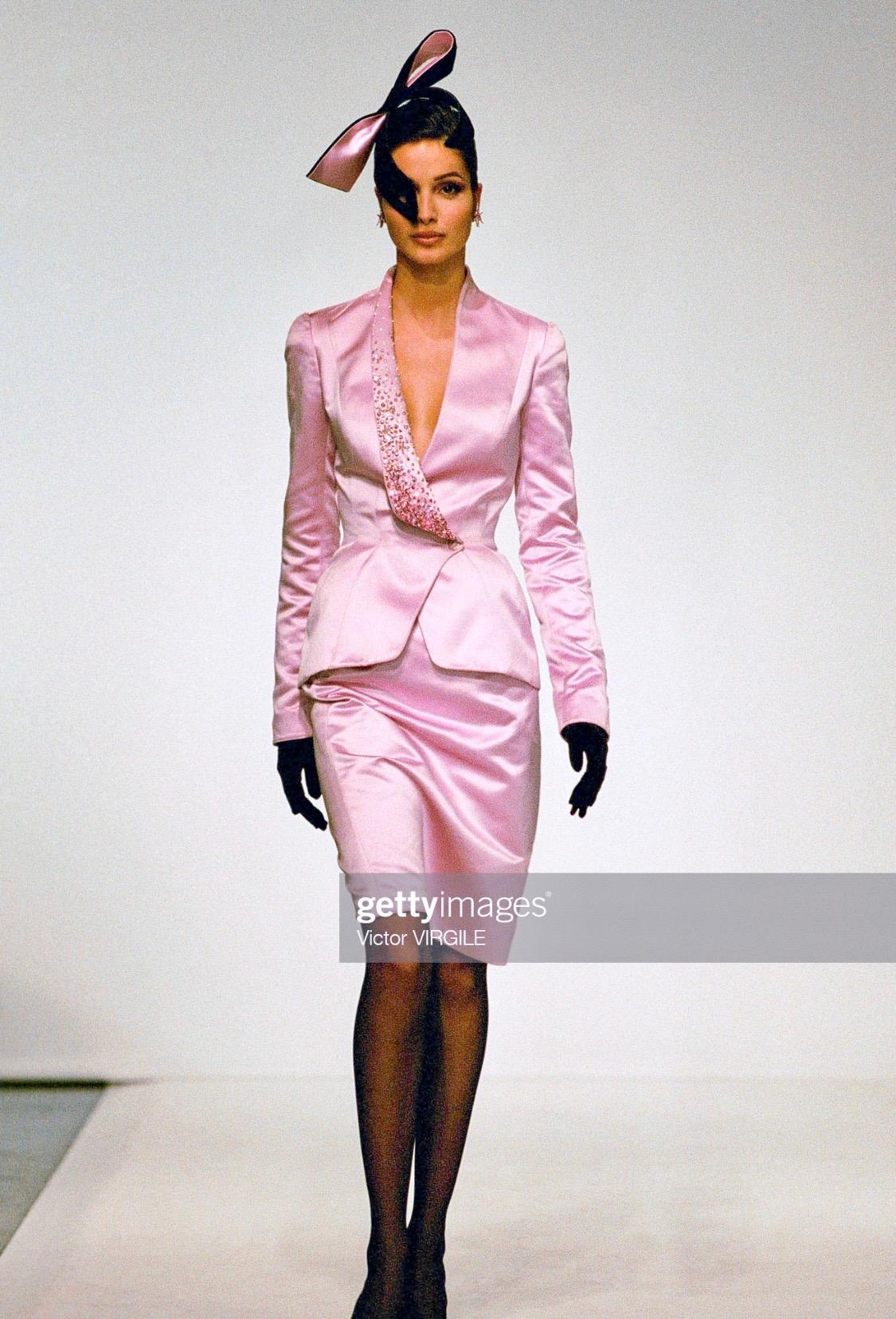 TheRealList presents: a black wool pantsuit designed by Thierry Mugler for his Fall/Winter 1999 collection. The right lapel is covered in pink and white rhinestones to create an elegant gradient effect. Unlike the pink variation of this jacket shown