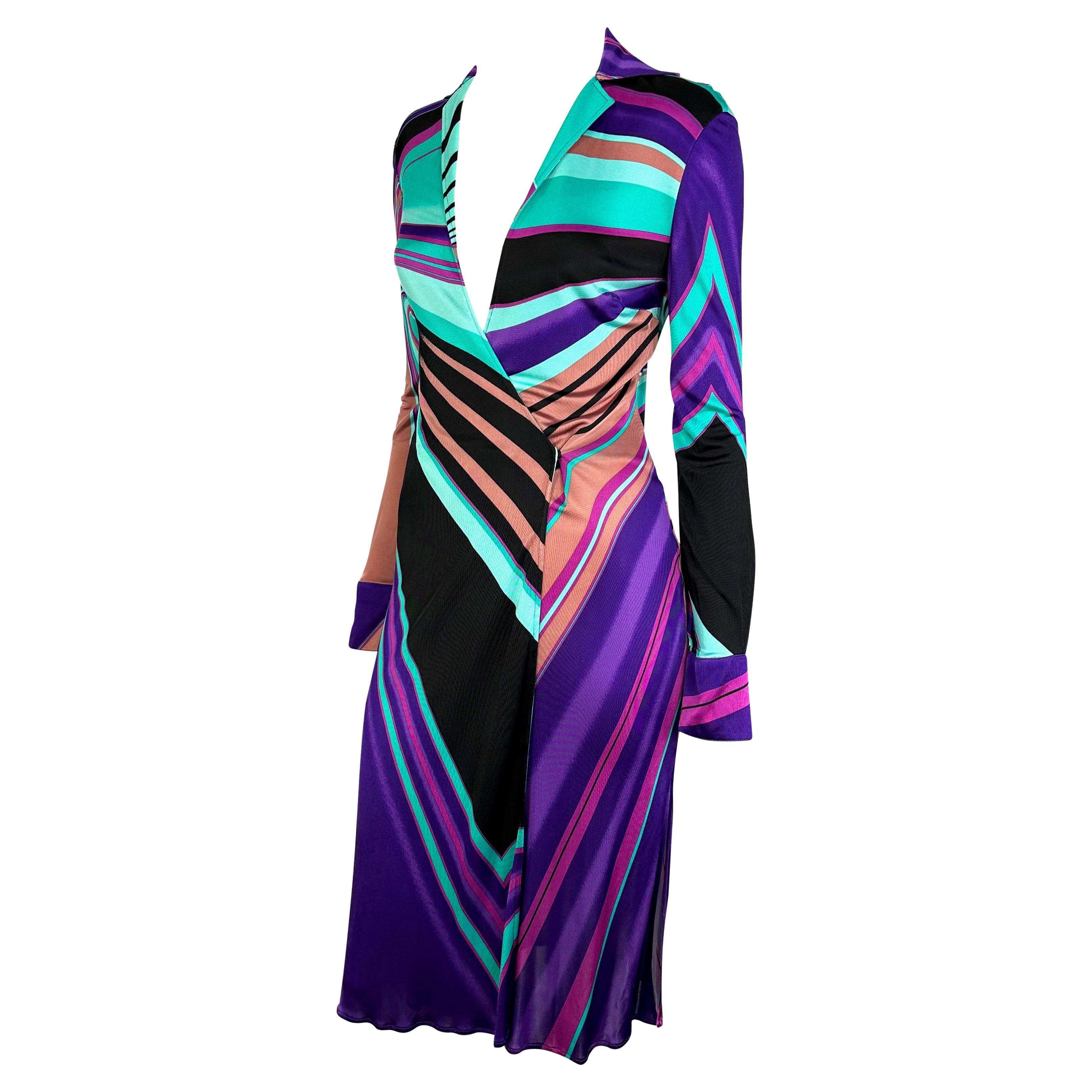 Presenting a fabulous blue and purple slinky Gianni Versace dress, designed by Donatella Versace. From the Fall/Winter 2000 collection, this dress is covered in a multicolor abstract print. The dress features a plunging neckline, collar, long