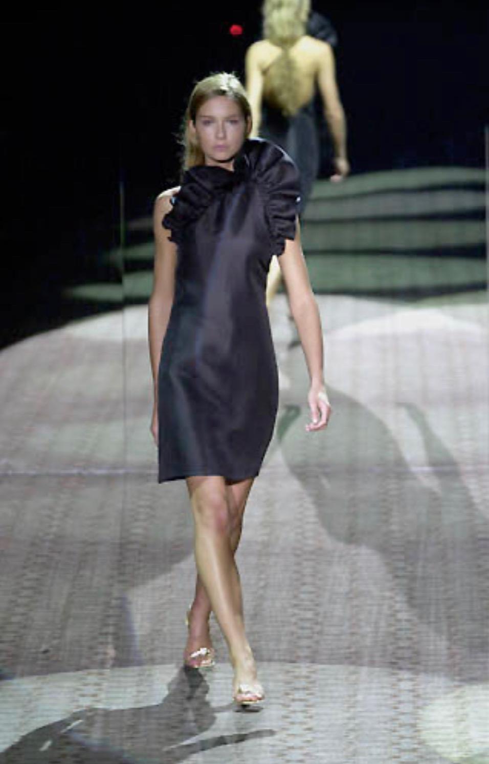 Presenting a stunning black silk taffeta Gucci halterneck dress, designed by Tom Ford. From the Fall/Winter 2000 collection, this dress debuted on the season's runway as part of look 50 modeled by  Ana Claudia Michels. This perfectly shiny silk