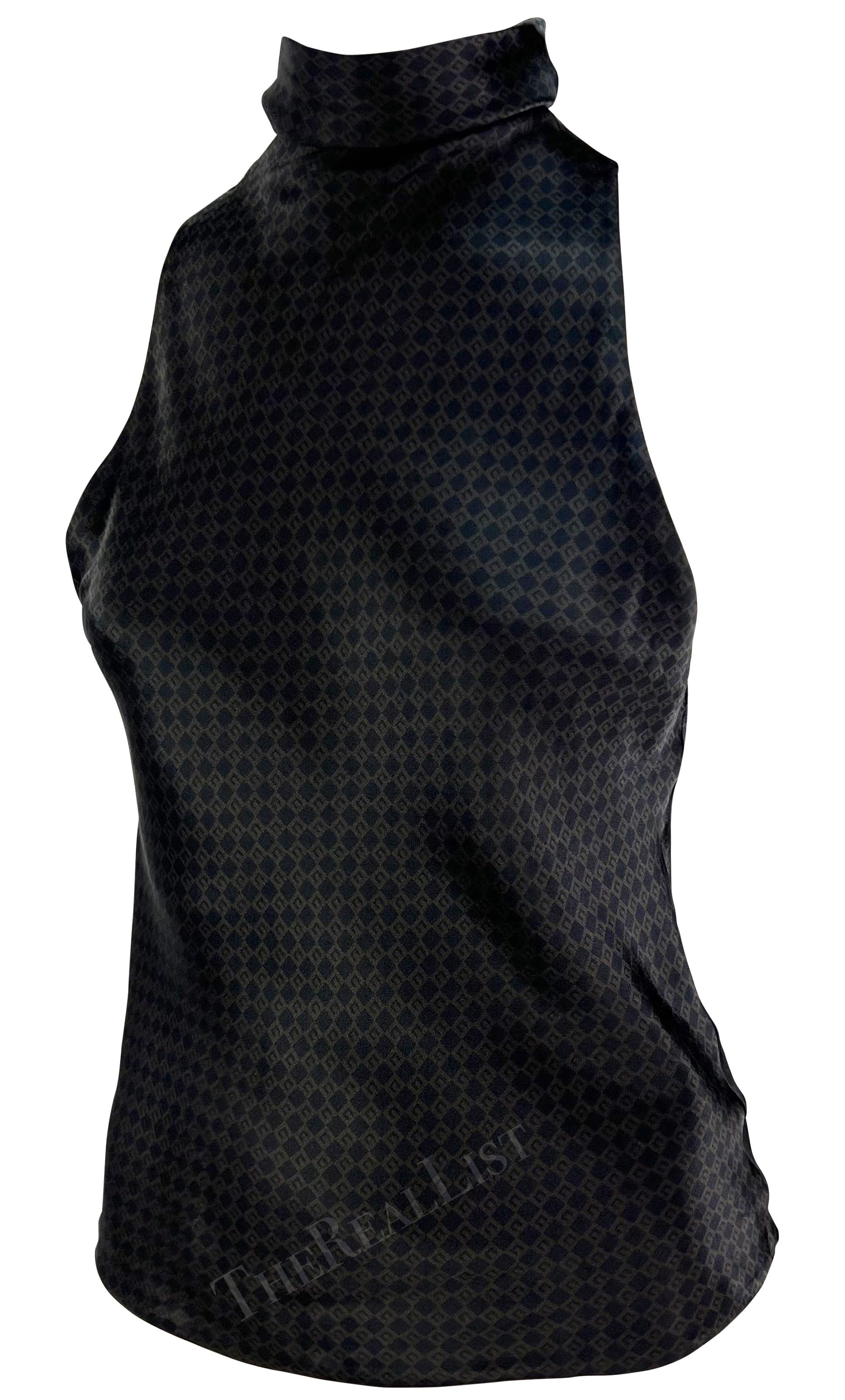 Presenting a brown silk Gucci 'G' monogram sleeveless top, designed by Tom Ford. From the Fall/Winter 2000 collection, this sleeveless top is covered in a square 'G' monogram pattern and features a mock neck. The top is made complete with gold hook