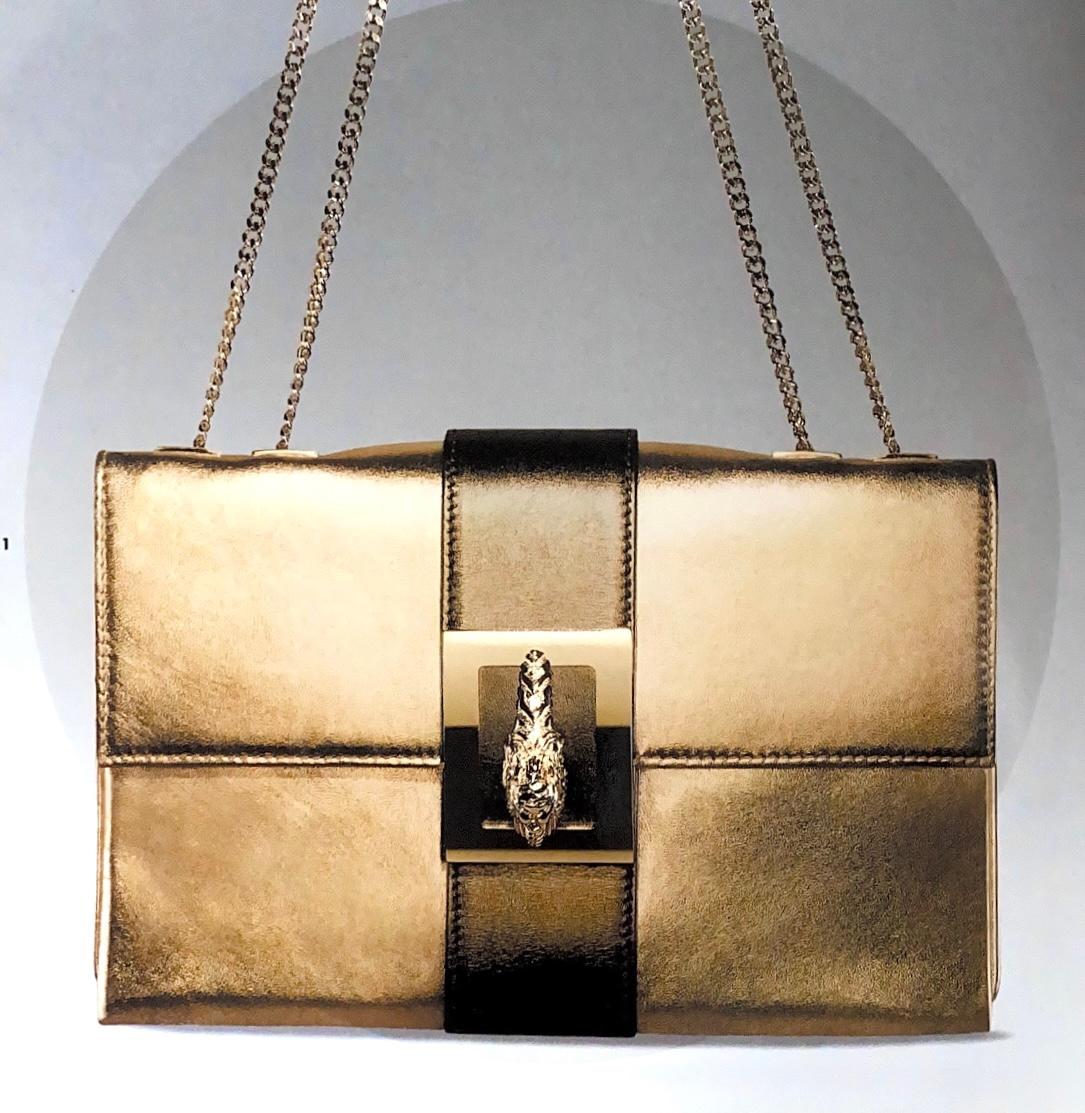 Presentin a gold-covered multi-style Gucci envelope bag, designed by Tom Ford. Constructed entirely of gold-colored leather and finished with gold accents, this bag is an iconic mix of Gucci heritage and Tom Ford's effortlessly sexy and chic