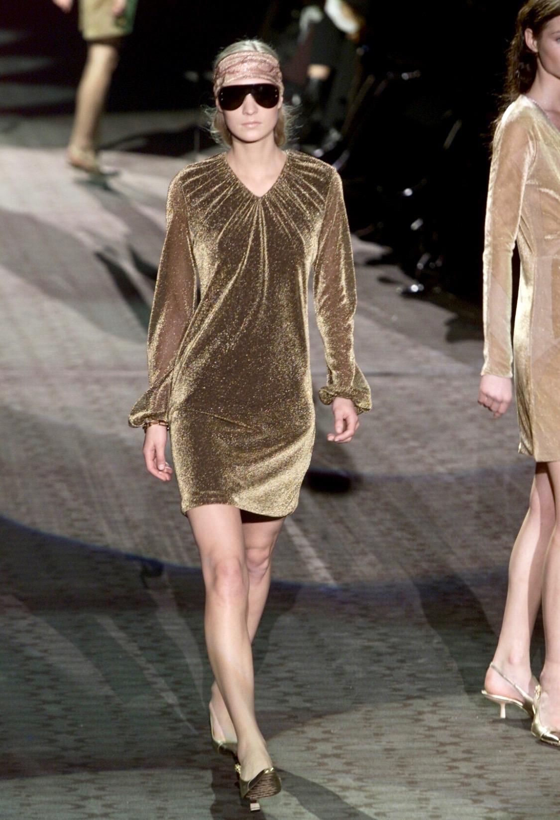 Presenting a shimmering disco-chic sheer gold blouse designed by Tom Ford for Gucci's Fall/Winter 2000. The dress version of this fabulous top debuted as look number 29 on Erika Wall on the season's runway. The sheer metallic fabric is layered at