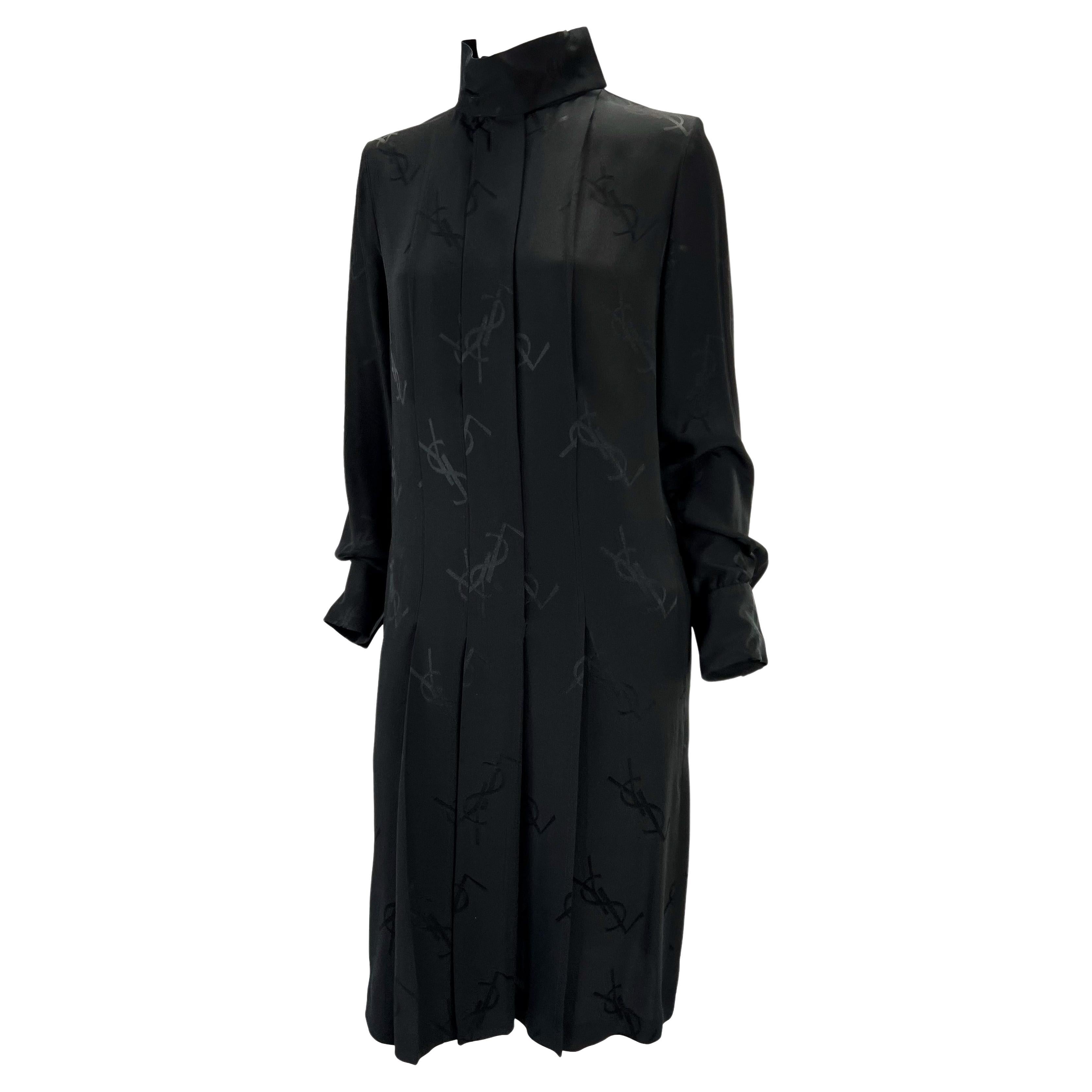 Presenting a gorgeous black silk pleated Yves Saint Laurent Rive Gauche monogram dress. From the Fall/Winter 2000 collection by Albert Elbaz, this long sleeve dress features a hidden button-up front, mock neck, flowing sleeves, and pleating at the