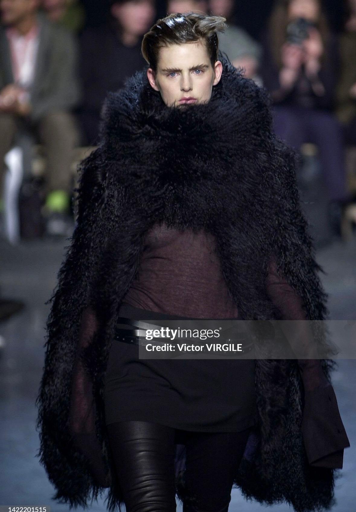 This Ann Demulemeester cape/poncho coat is constructed entirely of luxurious black Mongolian lamb fur. With several ways to style this piece, this asymmetrical Ann Demulemeester fur shawl is a cold-weather must-have. 

Approximate measurements:
Size