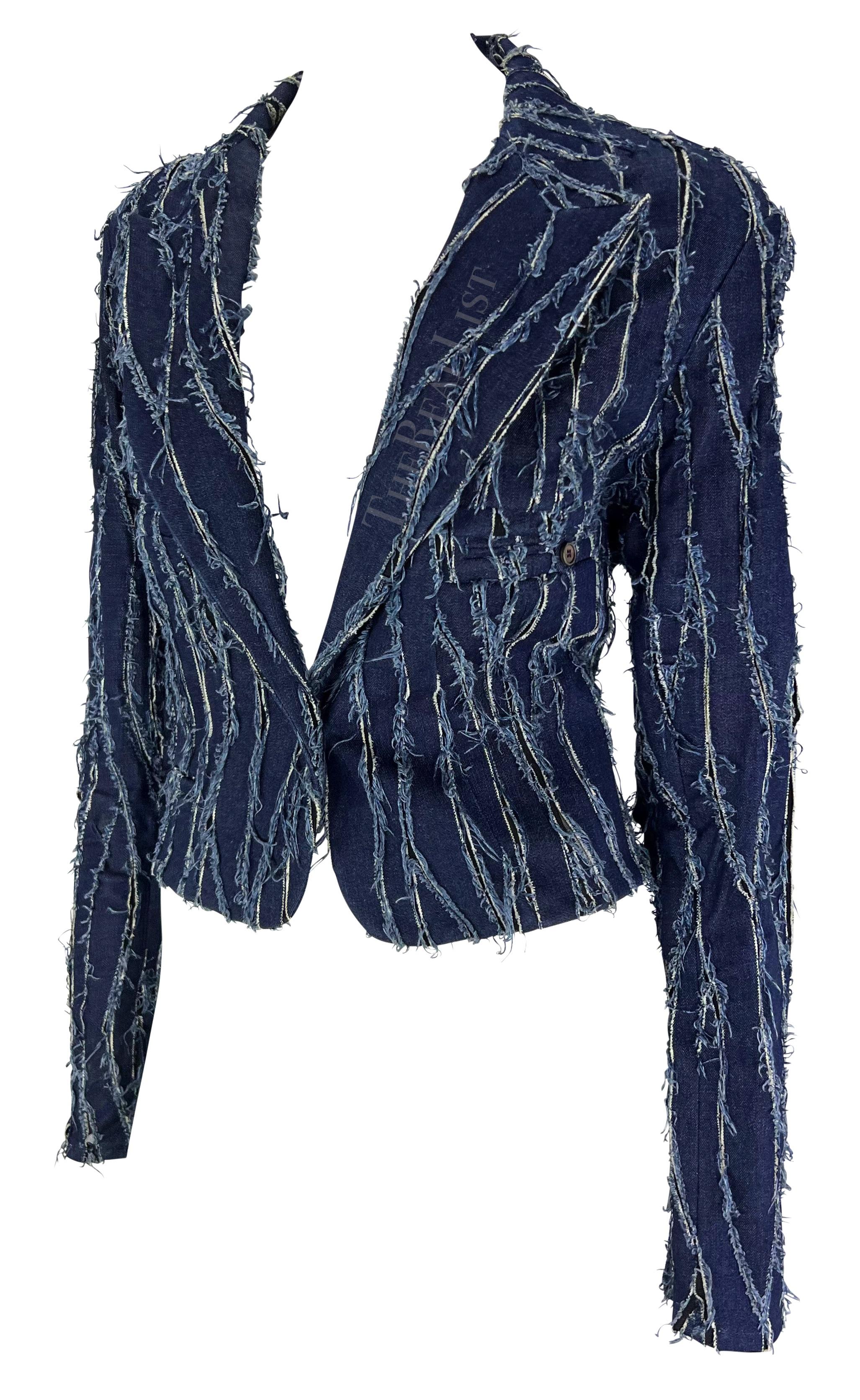 Presenting an incredible distressed Christian Dior denim blazer, designed by John Galliano. From the Fall/Winter 2001 collection, this chic cropped blazer is constructed of distressed denim patches placed atop mesh fabric that is playfully featured