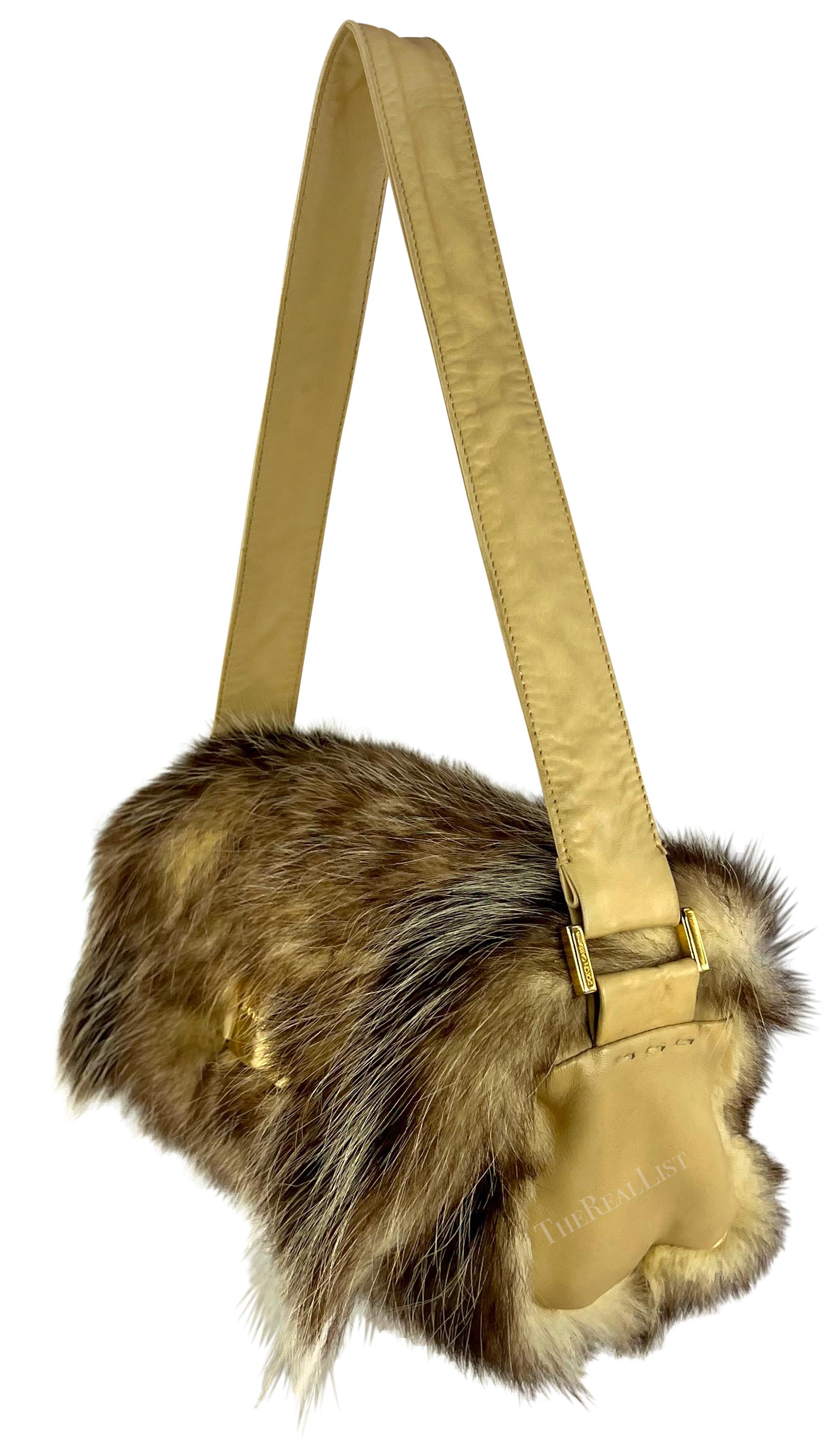 From the Fall/Winter 2001 collection, this ultra-chic tan fur Dolce & Gabbana shoulder bag is constructed of genuine fur with a tan leather strap and sides. Slightly hidden by the fur, this fabulous bag is complete with a gold-tone 'Dolce & Gabbana'