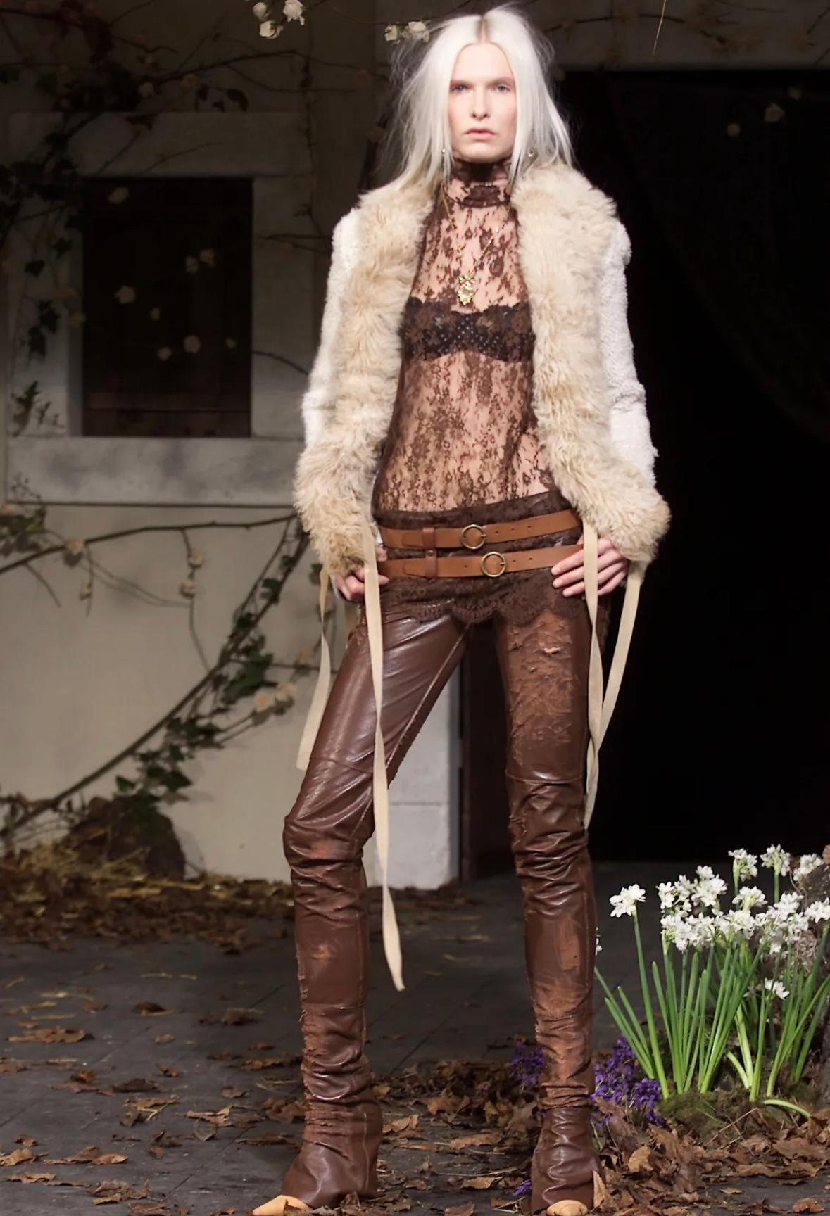 This beige Mongolian lamb shearling jacket from Dolce & Gabbana’s Fall/Winter 2001 collection features a plush, textured collar and trim. A variation of this jacket debuted on the season's runway as part of look 6. Crafted for warmth and style, it