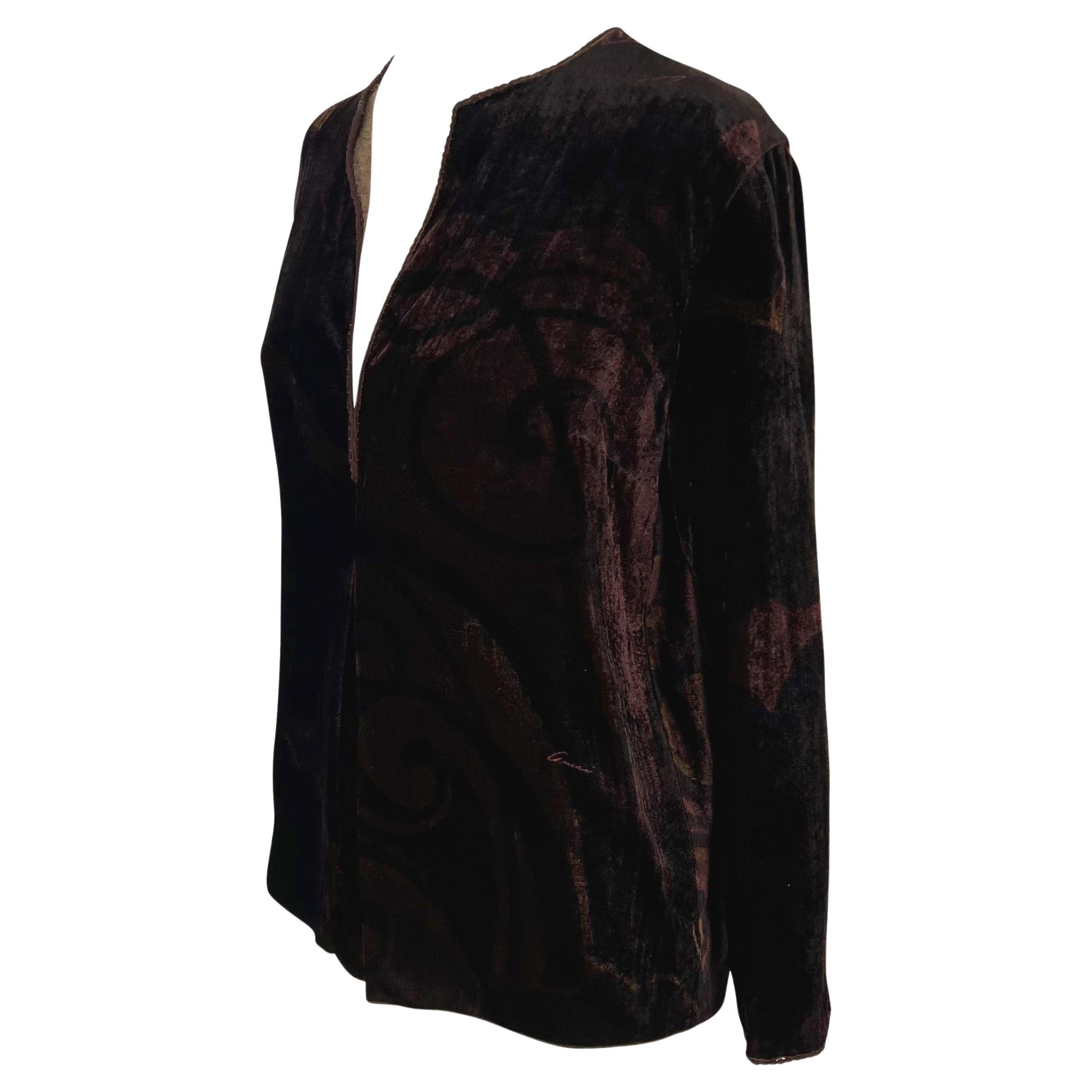 Presenting a luxurious brown velvet Gucci tunic top, designed by Tom Ford. From the Fall/Winter 2001 collection, this loose-fitting top features a plunging v-neckline, a small pleat below the neckline, and an abstract print with 'Gucci' written in