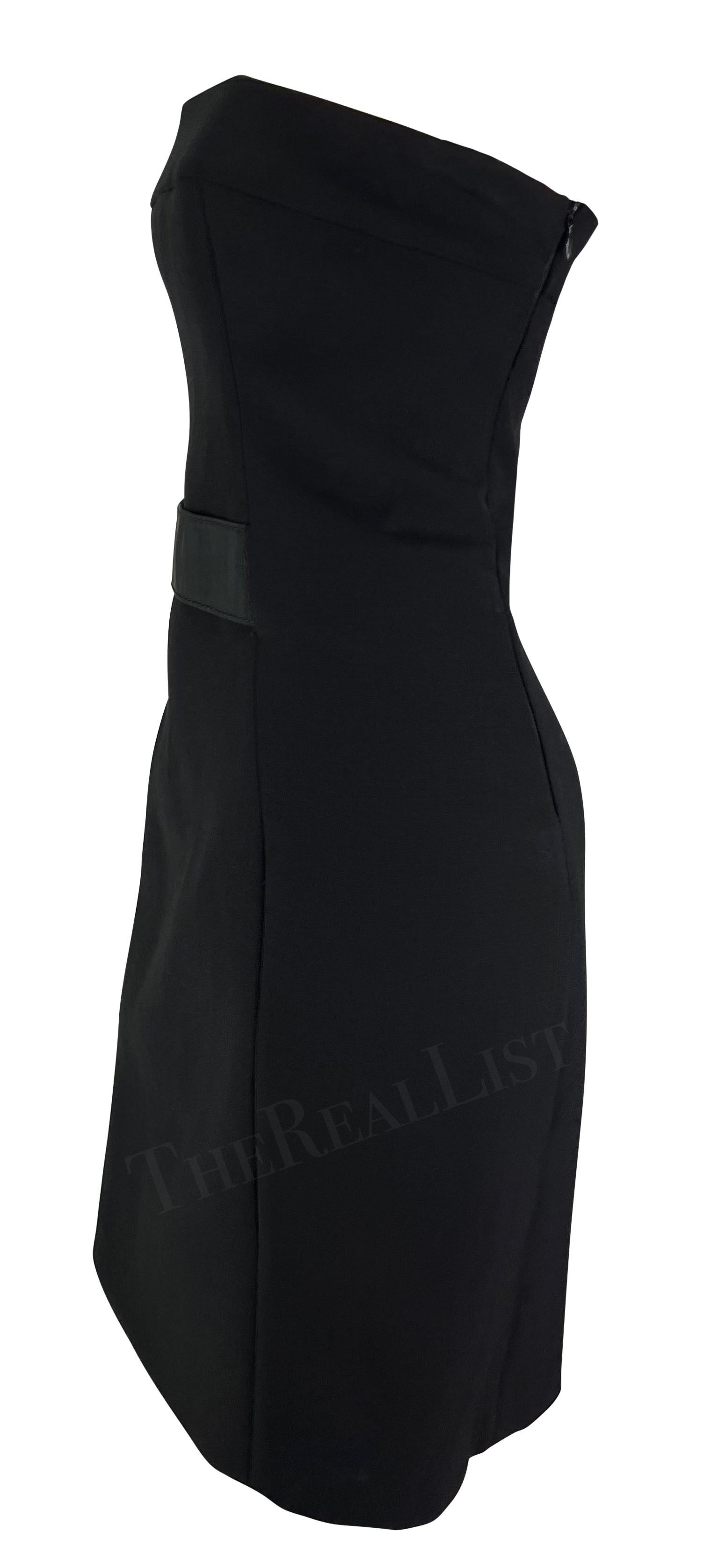 Presenting a black strapless Gucci dress, designed by Tom Ford. From the Fall/Winter 2001 collection, this strapless wool dress features a small strap accent across the waist. This fitted Gucci by Tom Ford mini dress is the perfect elevated addition