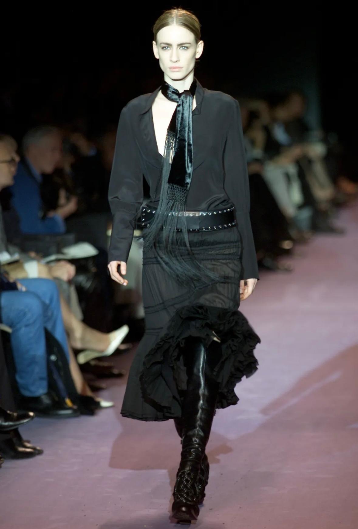 This black flare skirt from Yves Saint Laurent’s Fall/Winter 2001 collection, designed by Tom Ford, features ruching and asymmetric seamed paneling. Finished with a ruffled hem with added volume, the skirt debuted on the season’s