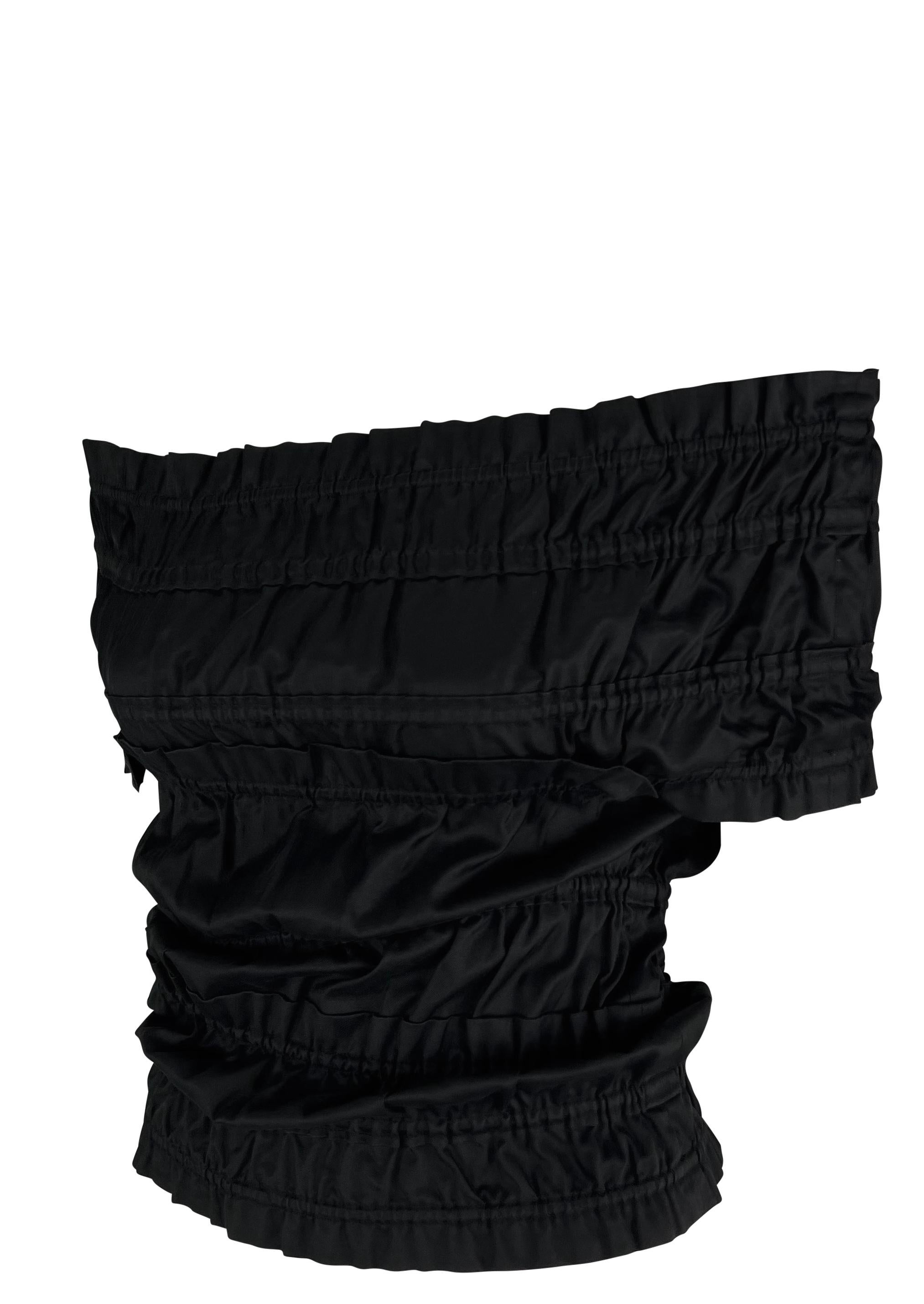 This off-the-shoulder black ruched cotton blouse is from Tom Ford's Fall/Winter 2001 collection for Yves Saint Laurent. It features a sleek, fitted design with textured ruching throughout.

Approximate measurements:
Size - F38
Bust: 32” - 34”
Waist: