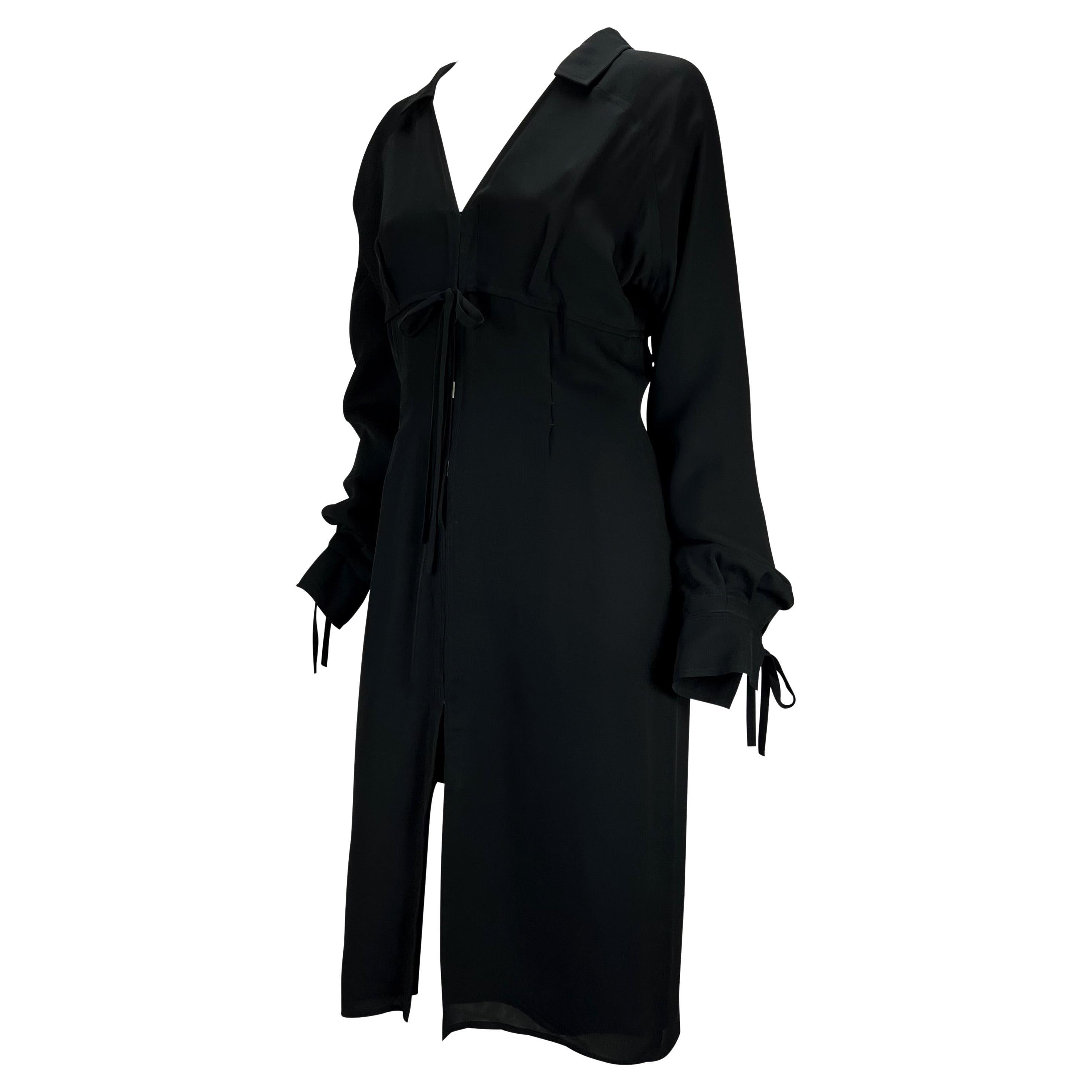 Presenting a black tie-up Yves Saint Laurent Rive Gauche shirt dress, designed by Tom Ford. From the Fall/Winter 2001 collection, this collared shirt dress features v-neckline, rectangular hook closures at the front, and ties at the bust and cuffs.