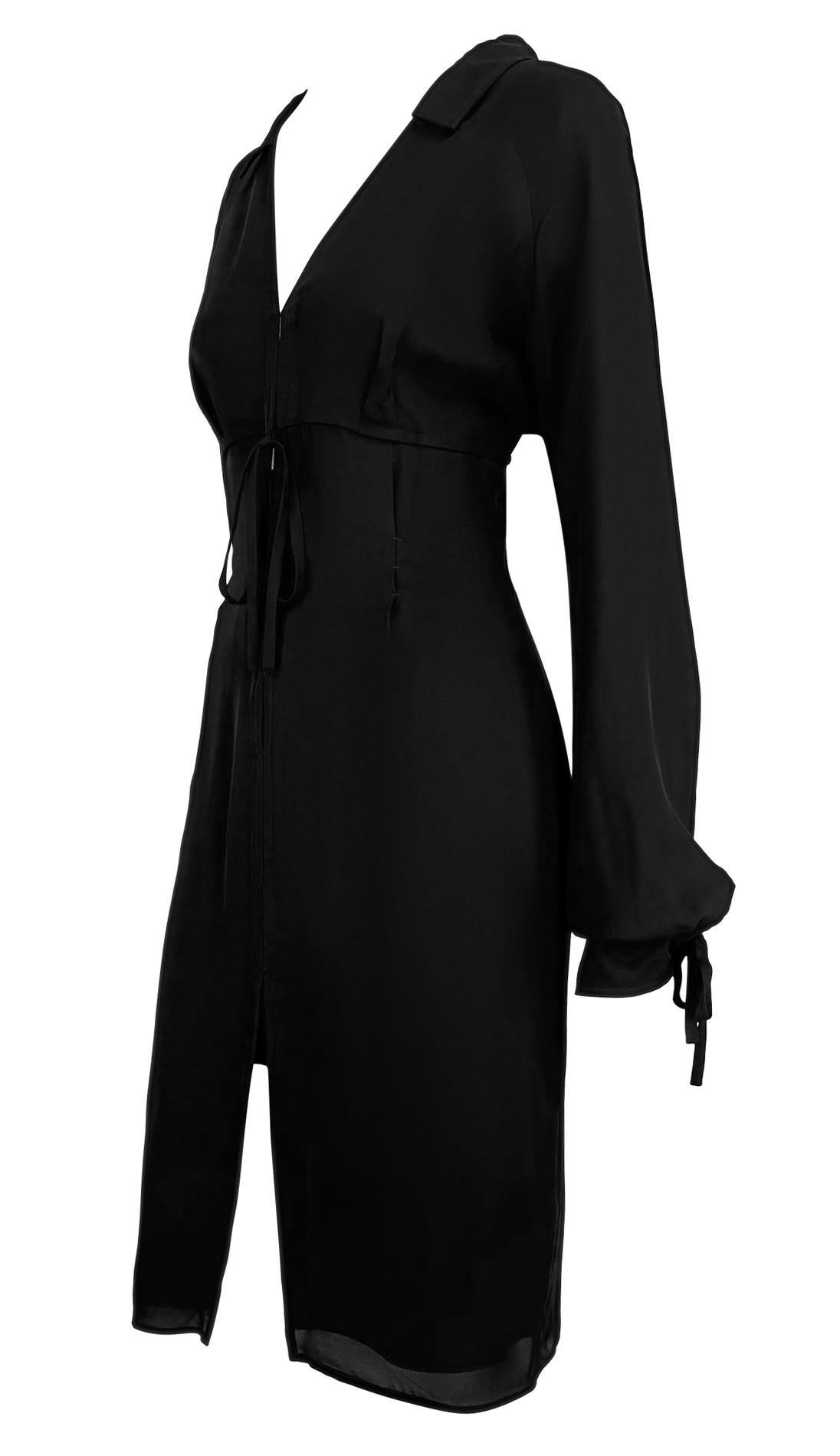 Presenting a black Yves Saint Laurent Rive Gauche tie-up shirt dress, designed by Tom Ford for the Fall/Winter 2001 collection. This sleek collared design features a deep V-neckline, rectangular hook closures along the front, and adjustable ties at