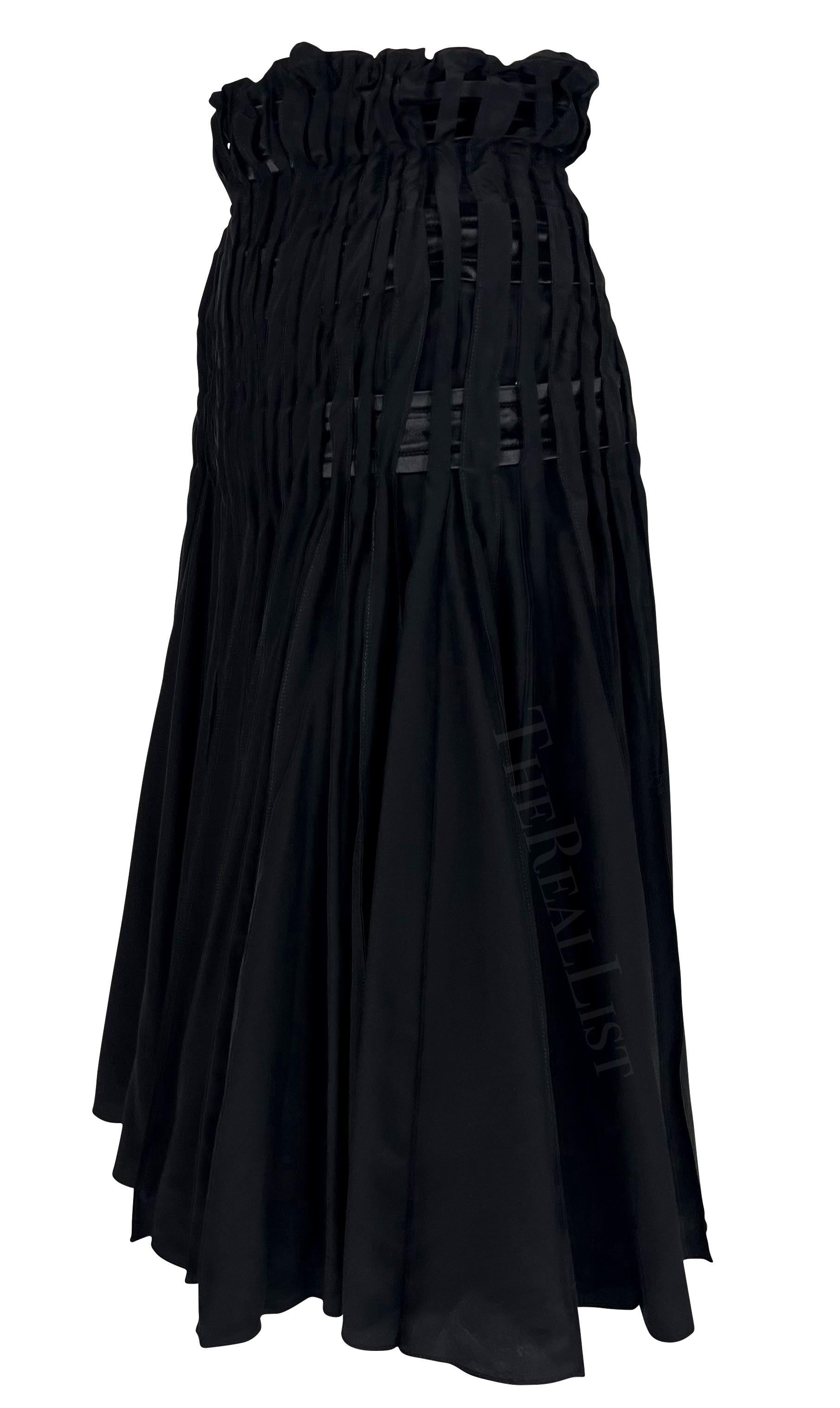 Presenting a black pleated Yves Saint Laurent Rive Gauche skirt, designed by Tom Ford. From the Fall/Winter 2001 collection, this fabulous flare skirt features a high waist and satin ribbons woven between pleats. An incredible early piece of Ford's
