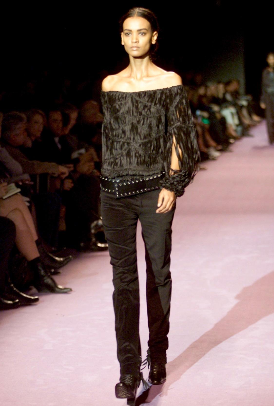 Presenting an incredible purple ribbon Yves Saint Laurent Rive Gauche blouse, designed by Tom Ford. From the Fall/Winter 2001 collection, this top debuted on the season's runway as part of look 12 modeled by Liya Kebede. This amazing top features