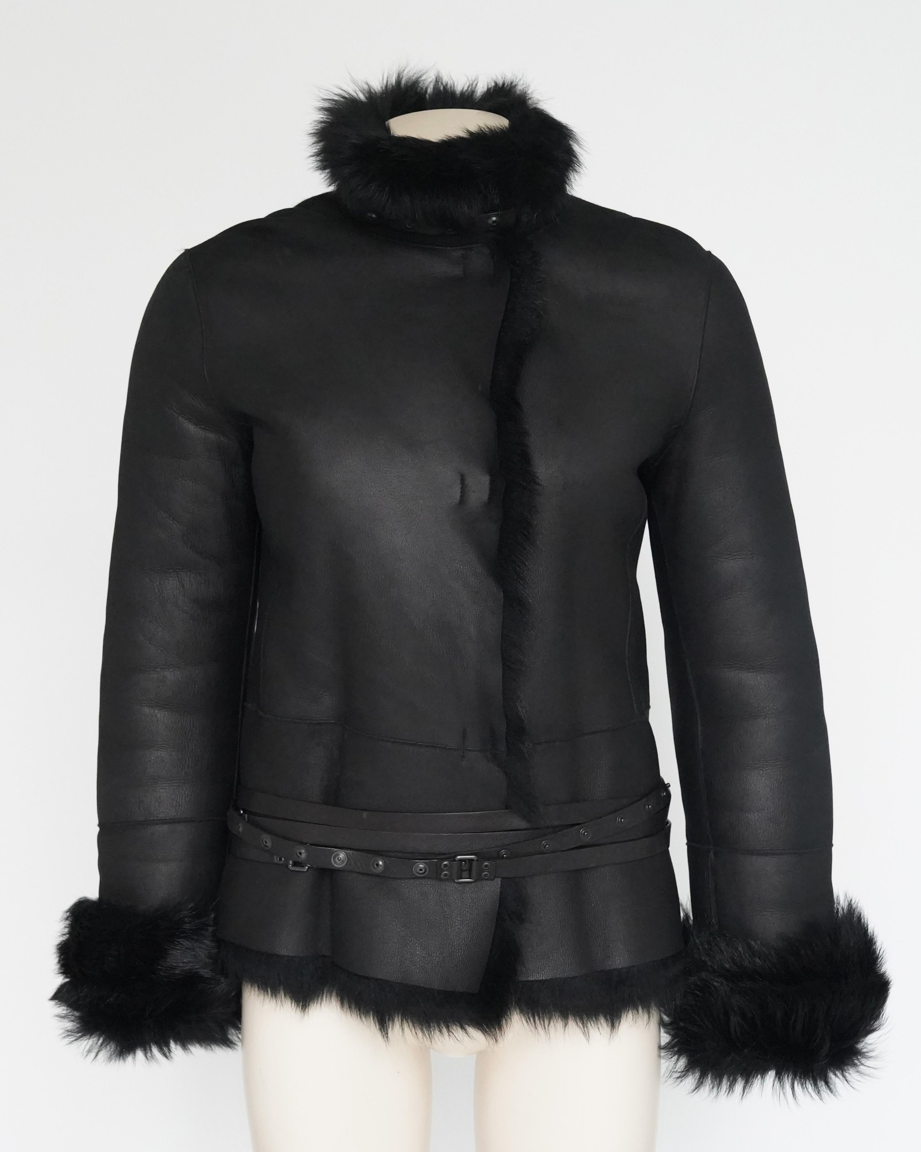 Presenting a F/W 2002 Gucci by Tom Ford Black Shearling Jacket that can be worn inside out. Featuring a studded leather waist belt with press stud closure that wraps around multiple times and threads through studded leather loops on the backside of