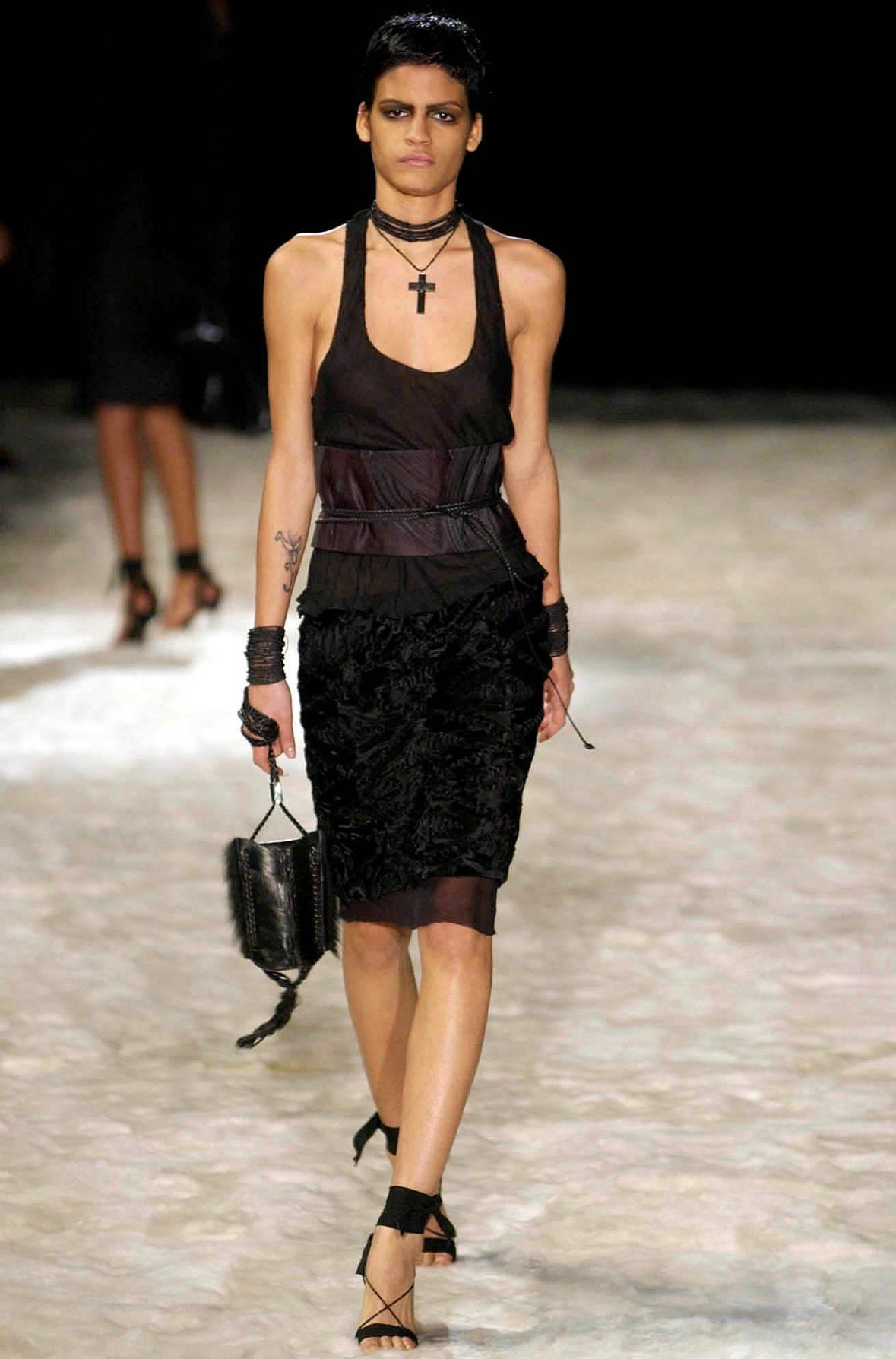TheRealList presents: an incredible brown carved wood Gucci bag, designed by Tom Ford. From the Fall/Winter 2002 collection, this gothic rock-inspired bag debuted on the season's runway as part of look 29, modeled by Anne Catherine Lacroix. This