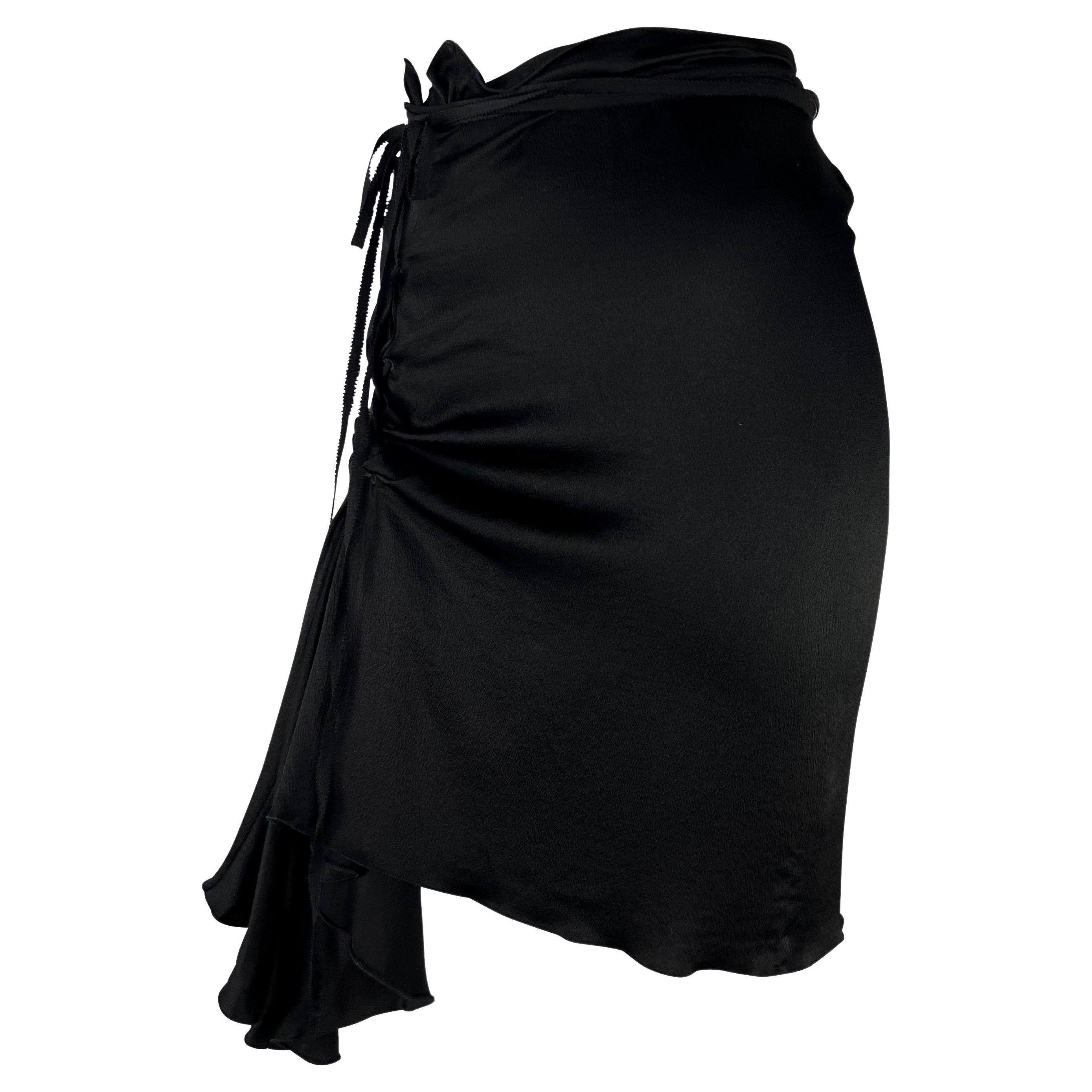 TheRealList presents: a black crepe silk Gucci skirt, designed by Tom Ford. From the Fall/Winter 2002 collection, this skirt is constructed entirely of crepe silk and features an asymmetric lace-up detail at the front which can be wrapped around the