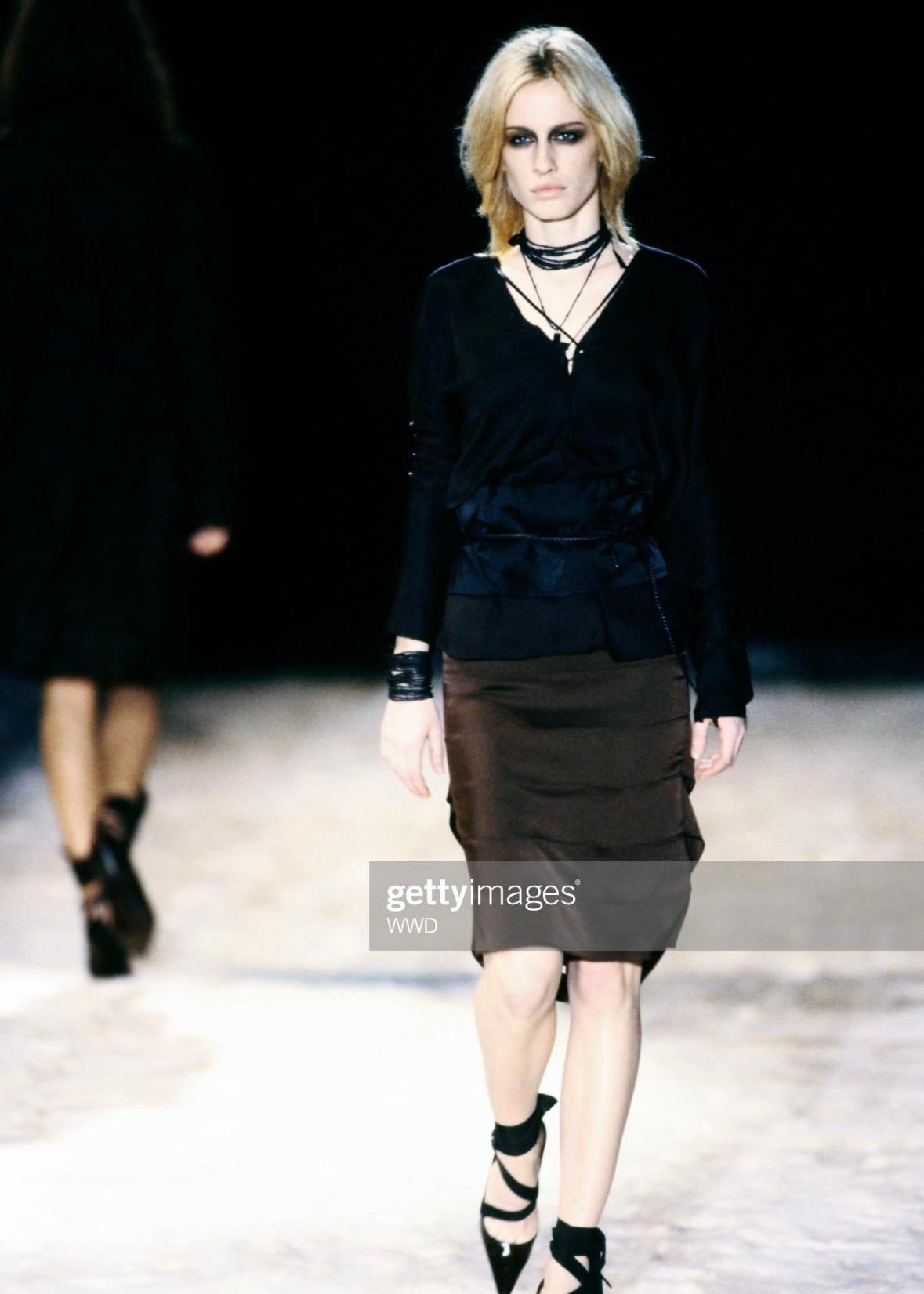Presenting a fabulous black silk lace-up Gucci top, designed by Tom Ford. From the iconic Spring/Summer 2002 collection, this top made its debut on the runway, modeled by Natasa Vojnovic on look 26. Crafted from luxurious black silk, this