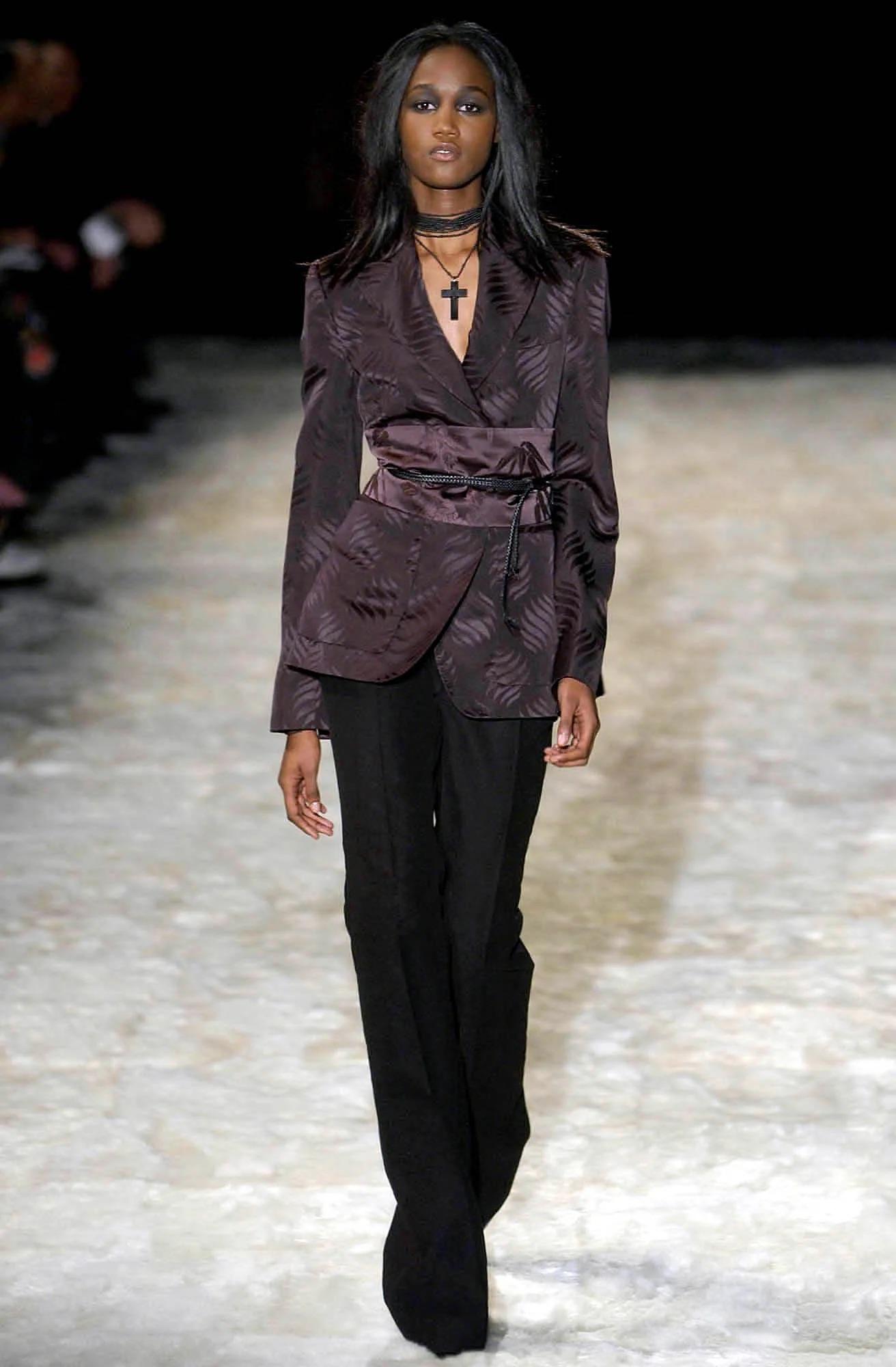Presenting a fabulous deep purple silk Gucci blazer, designed by Tom Ford. From the Fall/Winter 2002 collection, this blazer debuted as part of look 18, modeled by Valery Prince. Constructed of lightly shiny silk with a leaf-like print, this open