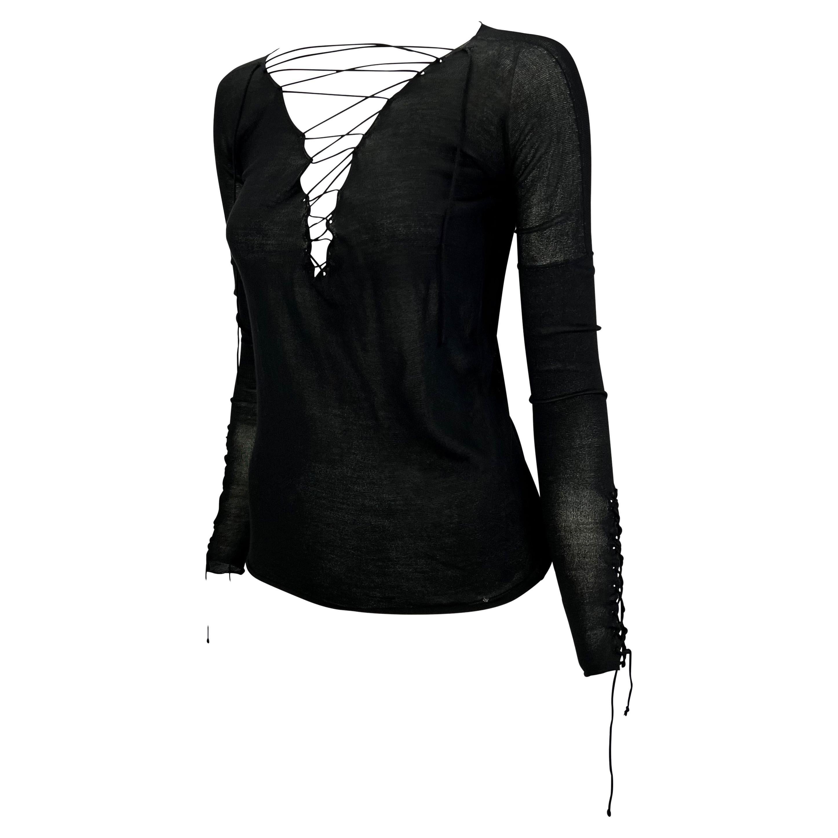 TheRealList presents: a fabulous lace-up long sleeve knit Gucci top, designed by Tom Ford. From the Fall/Winter 2002 collection, this rocker chic top features a plunging neckline with a lace-up detail. The top also features lace up details on the