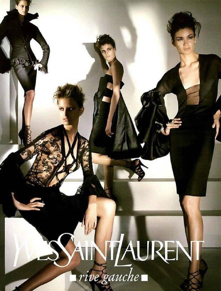 Yves Saint Laurent by Tom Ford Fall Winter 2002 lace up front black blouse. Runway look 3, as featured in a number of campaigns. Features iconic cross over detailing, semi-sheer body, balloon billow sleeves and button cuff closure. In great vintage