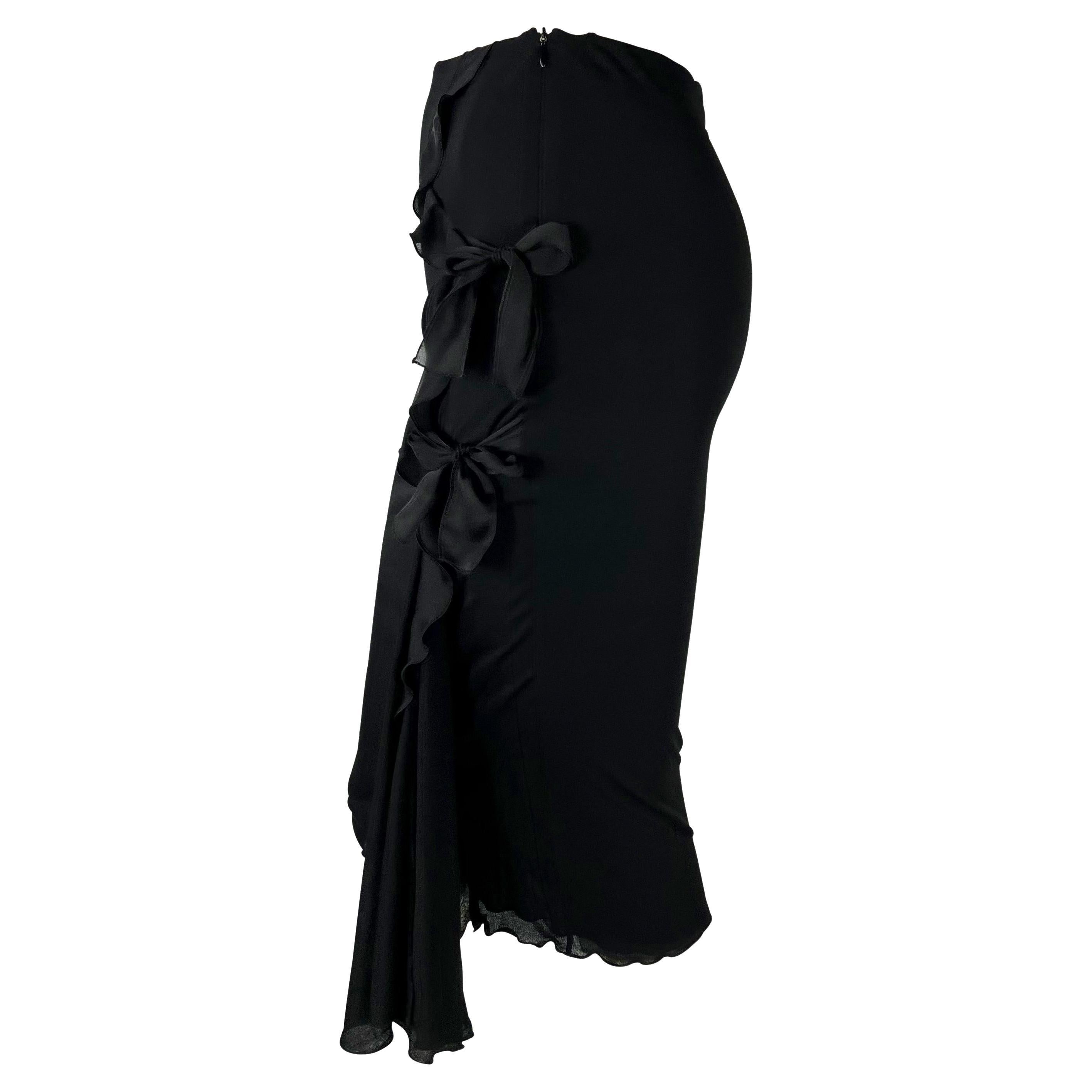 Presenting a stunning black ruffle Yves Saint Laurent Rive Gauche skirt, designed by Tom Ford. From the Fall/Winter 2002 collection, this fabulous form-fitting skirt features ruffles that cascade down one side and is made complete with two bows. Add