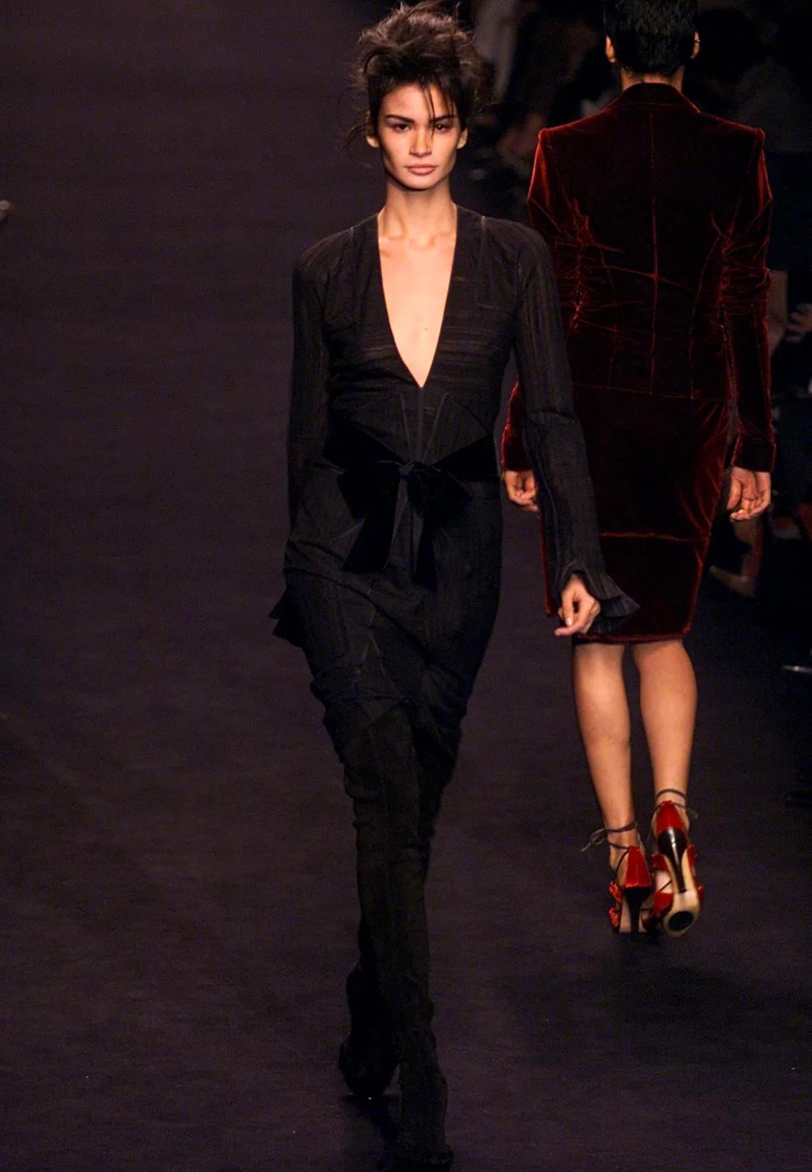 Presenting a fabulous black pleated Yves Saint Laurent Rive Gauche dress, designed by Tom Ford. From the Fall/Winter 2002 collection, this dress is constructed of semi-sheer layered fabric, this ultra-sexy dress features a plunging neckline and bell