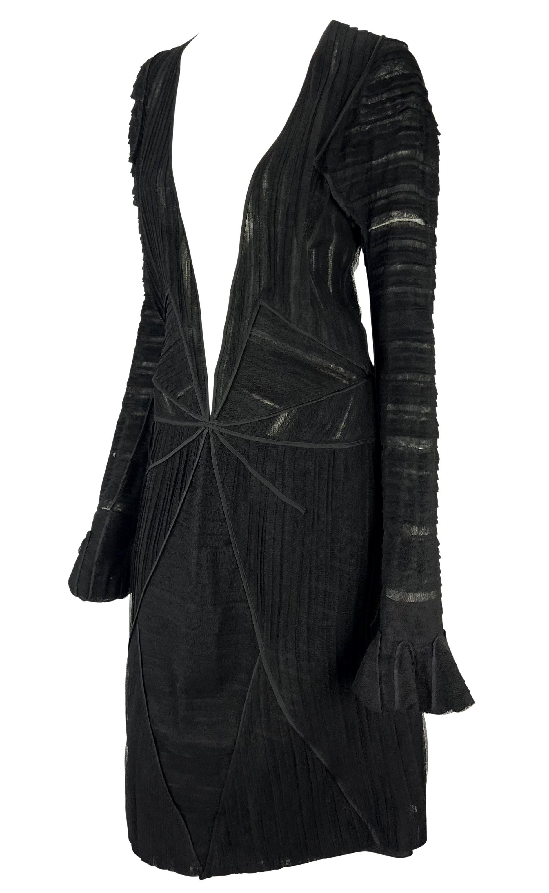 Presenting a fabulous black pleated Yves Saint Laurent Rive Gauche dress, designed by Tom Ford. From the Fall/Winter 2002 collection, this dress is constructed of semi-sheer layered fabric, this ultra-sexy dress features a plunging neckline and bell