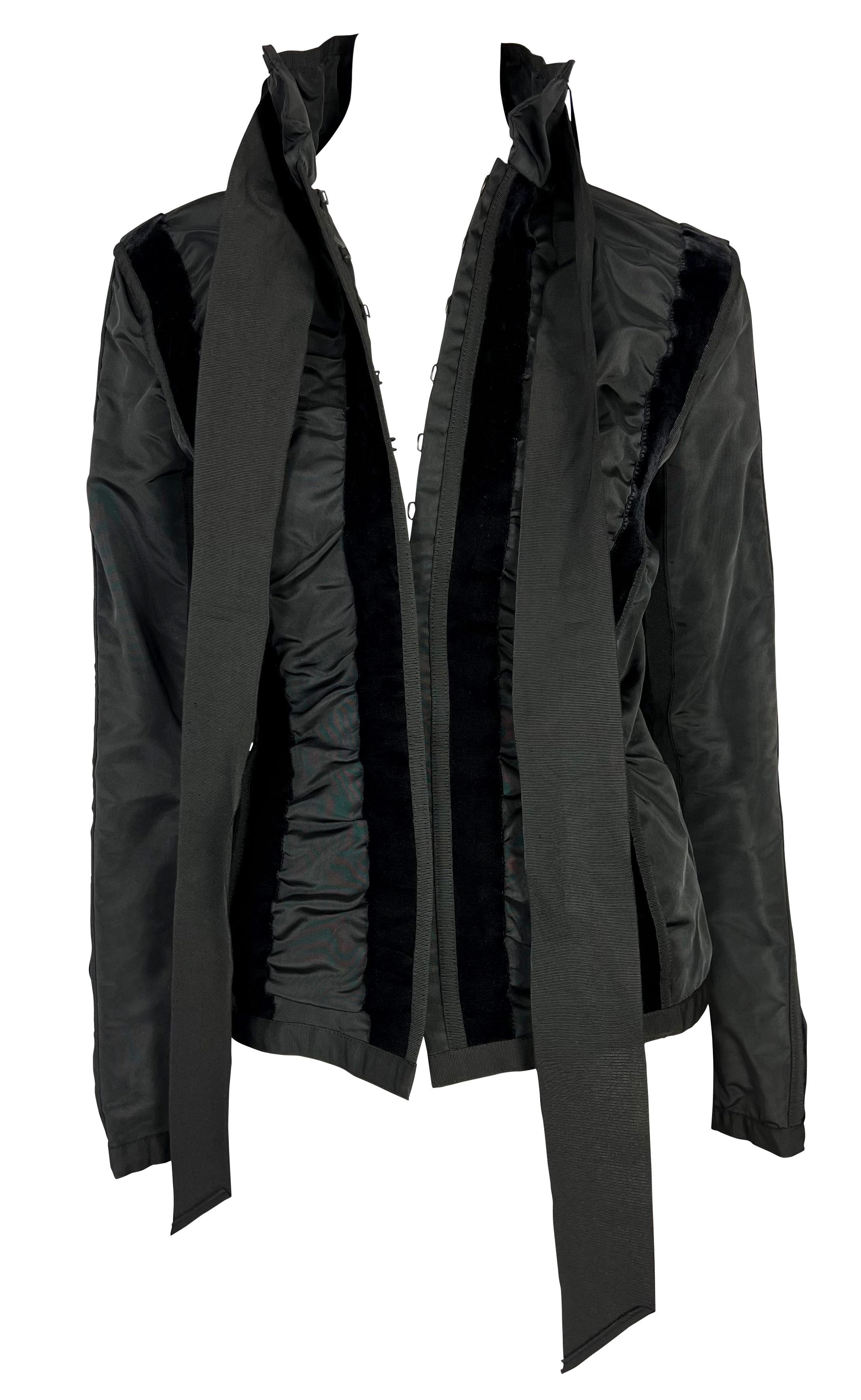 Presenting a black ruffled and velvet Yves Saint Laurent Rive Gauche jacket, designed by Tom Ford. From the Fall/Winter 2002 collection, this versatile jacket features ruffled panels throughout separated by vertical strips of velvet. The jacket is