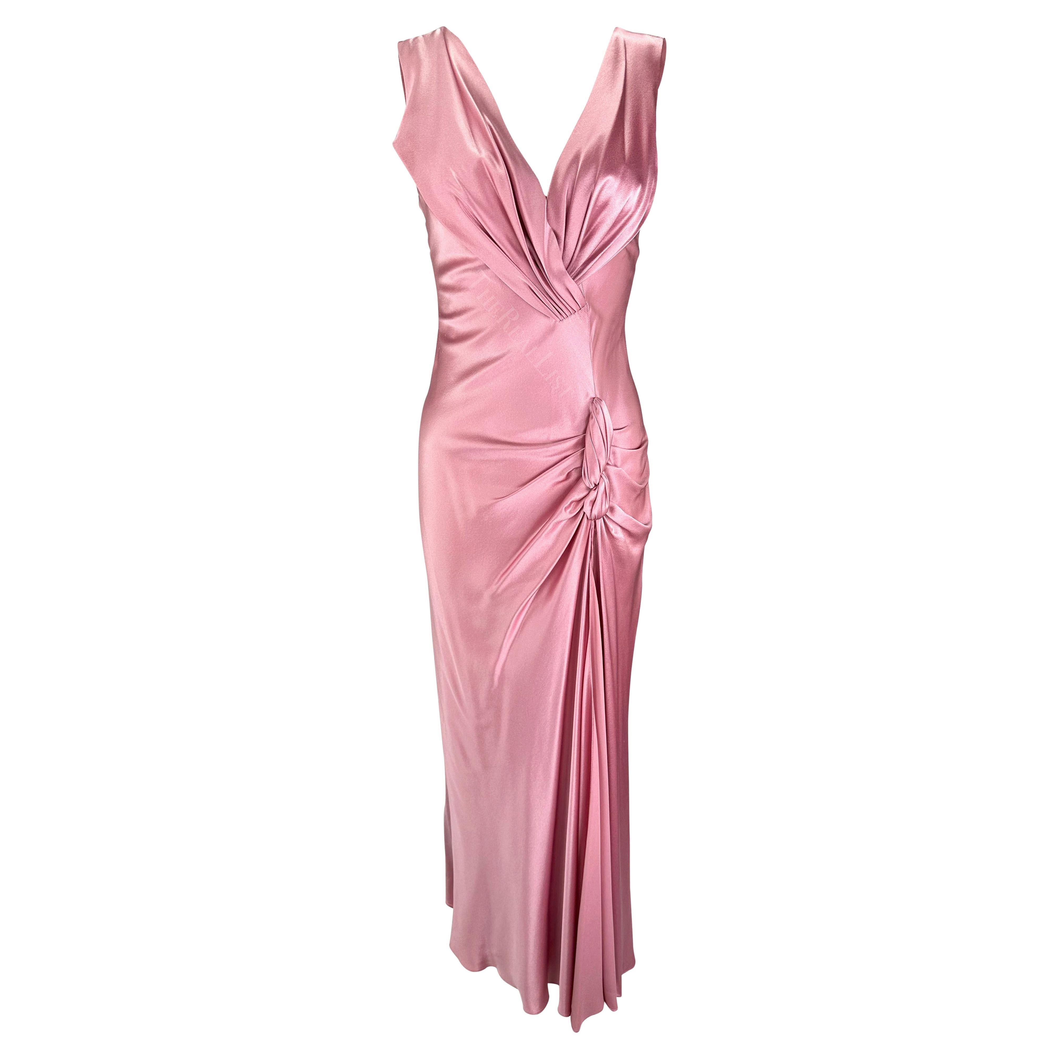 Presenting an incredible light pink Christian Dior gown, designed by John Galliano. From the Fall/Winter 2003 collection, this gown showcases the luxurious allure of light pink silk satin. The sleeveless design, adorned with a deep v-neckline and