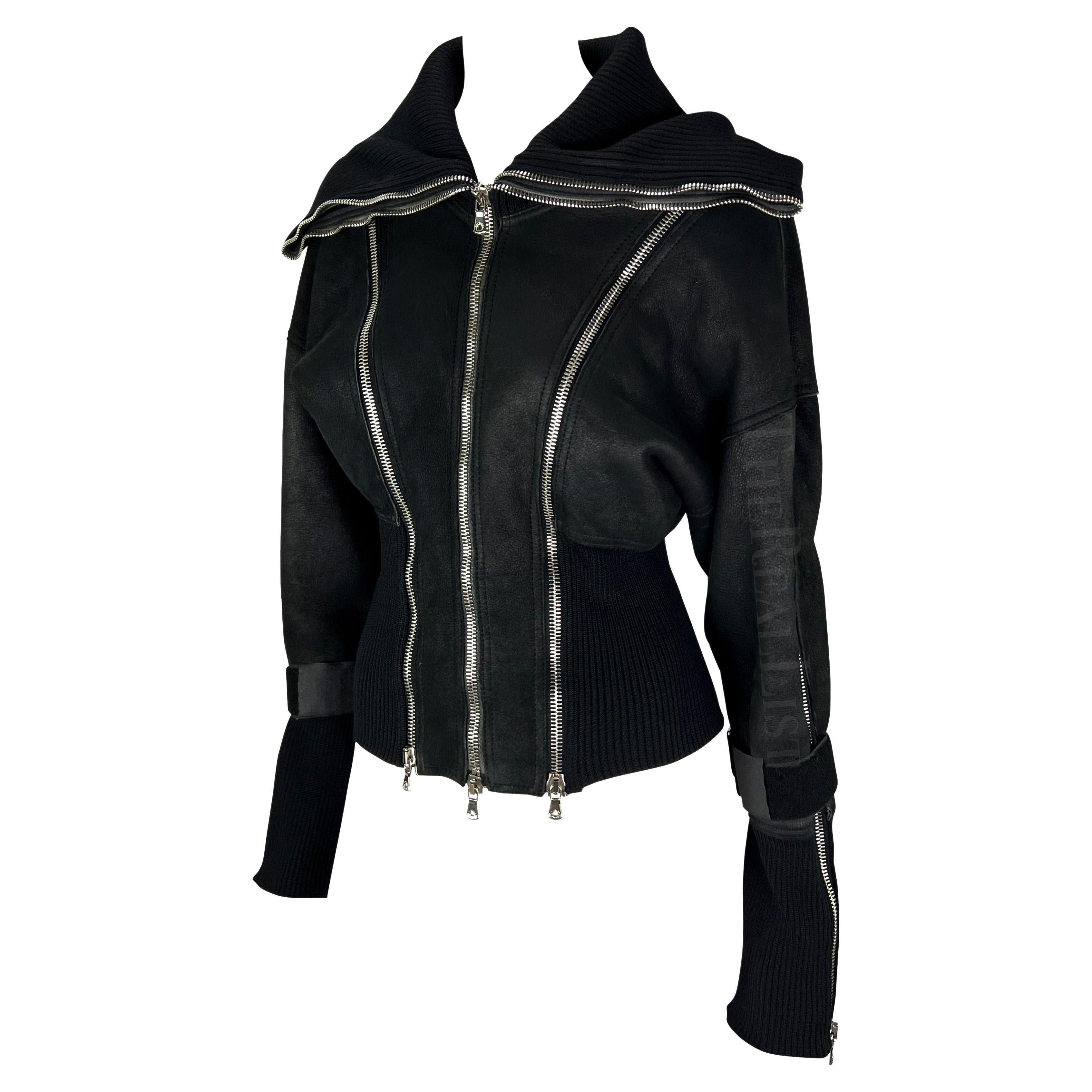 Presenting a fabulous black shearling Dolce & Gabbana jacket. From the Fall/Winter 2003 collection, this jacket is constructed of a suede exterior and shearling interior. Covered in large silver-tone zippers, this jacket features velcro straps at