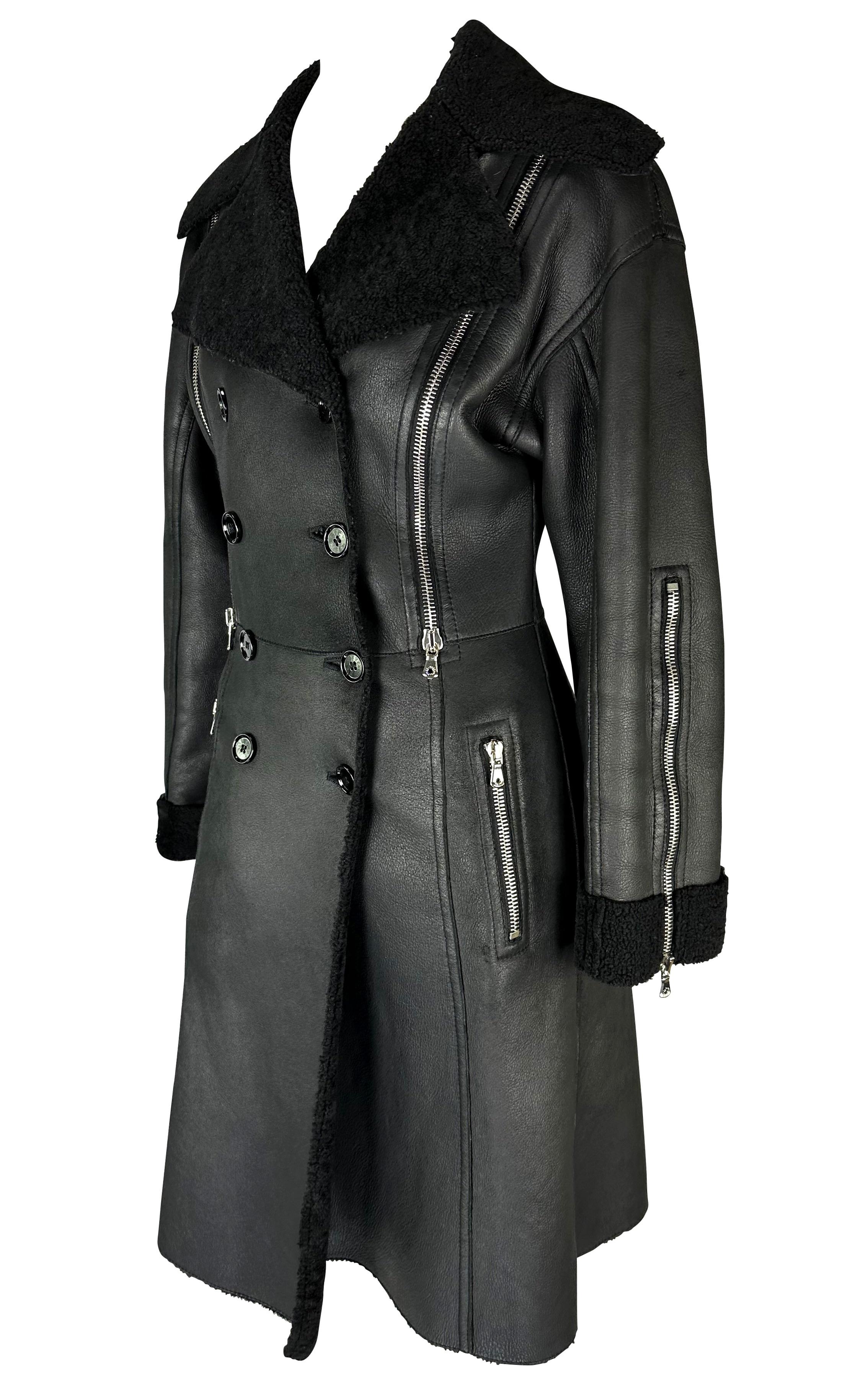Presenting a fabulous black shearling double-breasted Dolce and Gabbana coat. From the Fall/Winter 2003 collection, this coat features a leather exterior with a shearling lining that is exposed at the lapel and cuffs. The jacket is made complete