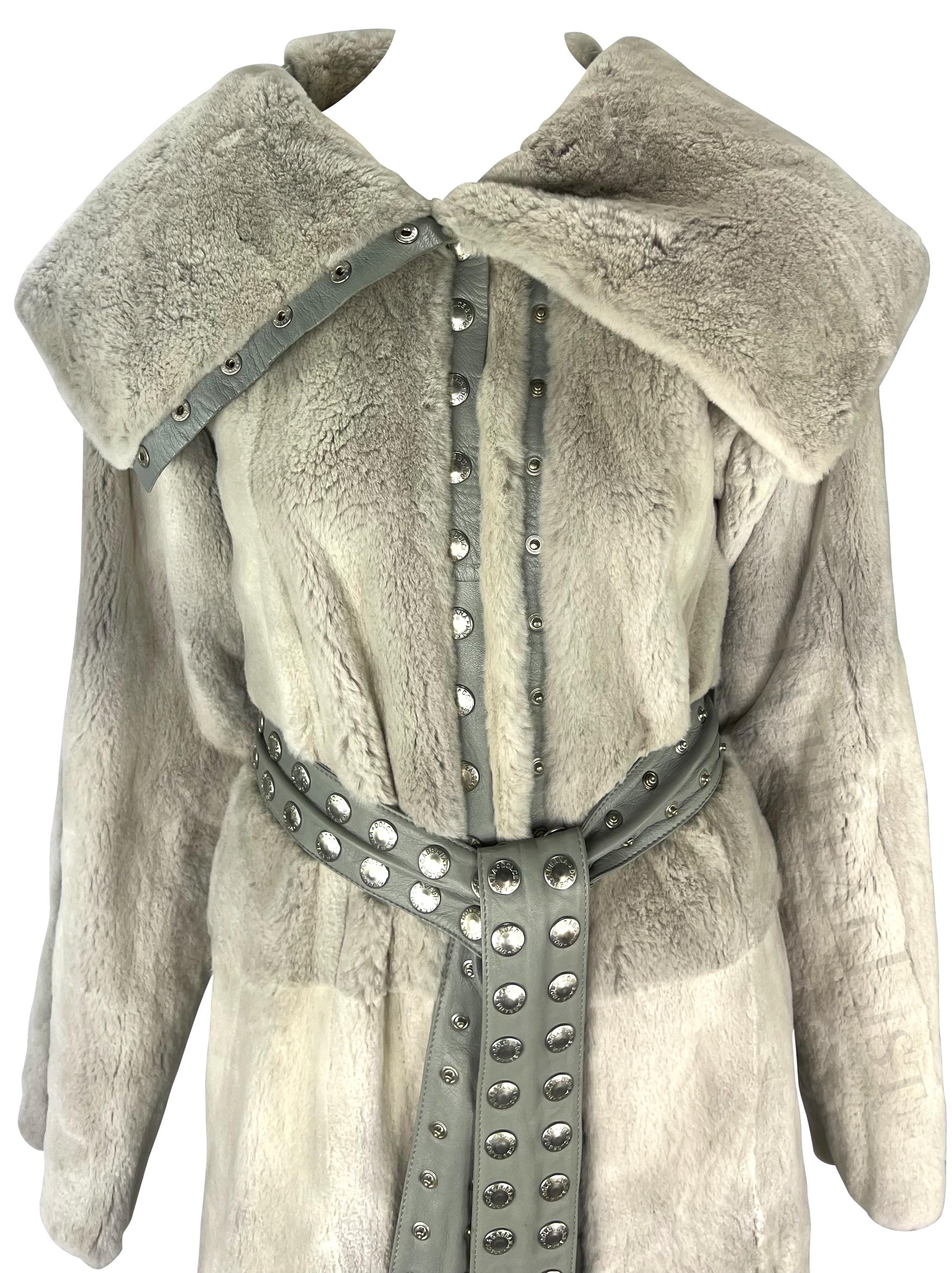 Presenting an incredible Dolce & Gabbana grey orylag fur coat. From the Fall/Winter 2003 collection, this fabulous unlined coat is constructed entirely of orylag fur with leather accents. Covered in silver-tone snaps, as many runway looks from this