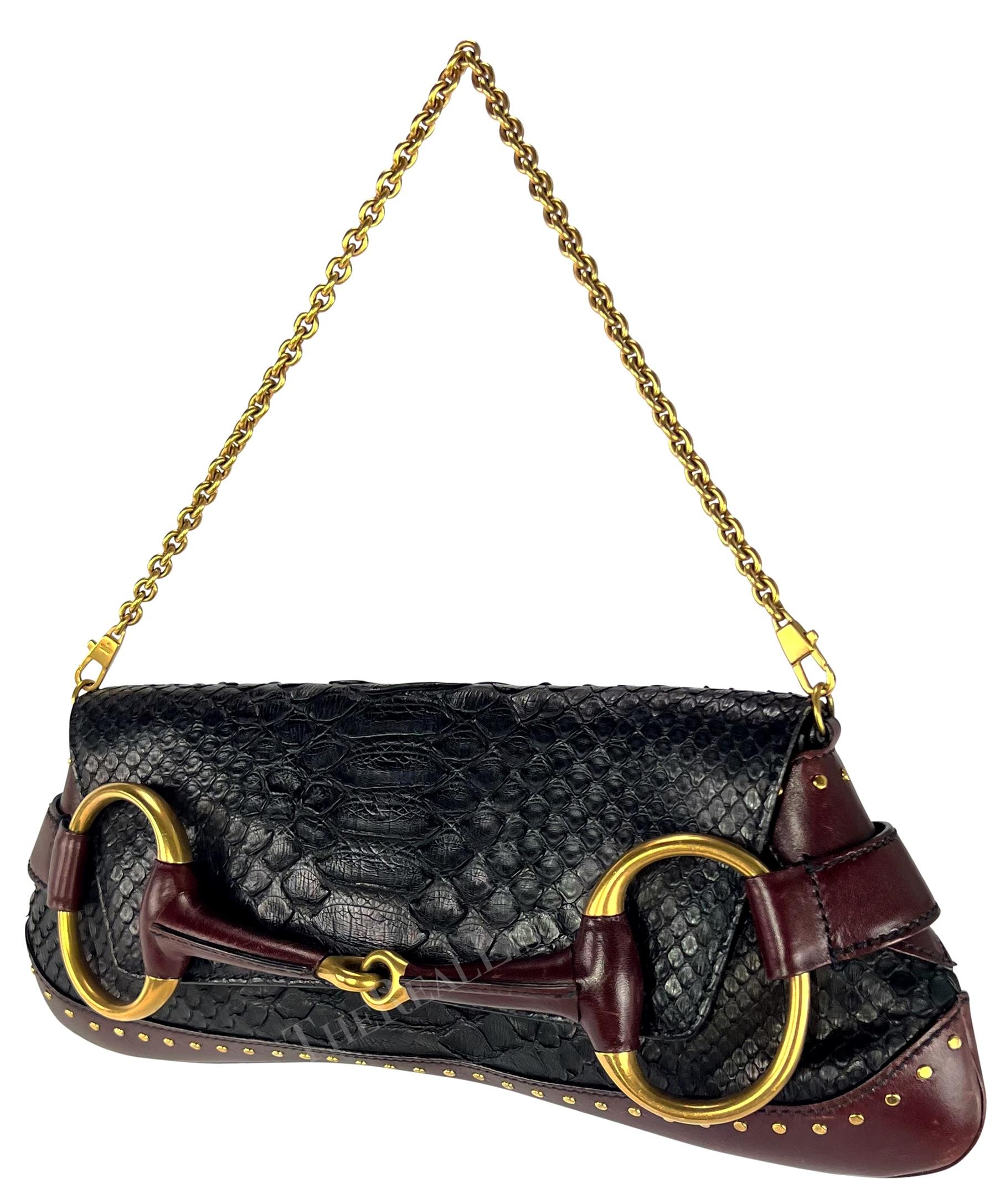 TheRealList presents: a fabulous black python Gucci horse bit bag, designed by Tom Ford. From the Fall/Winter 2003 collection, this horse bit style bag is constructed of black python skin with burgundy leather accents. The bag features a flap