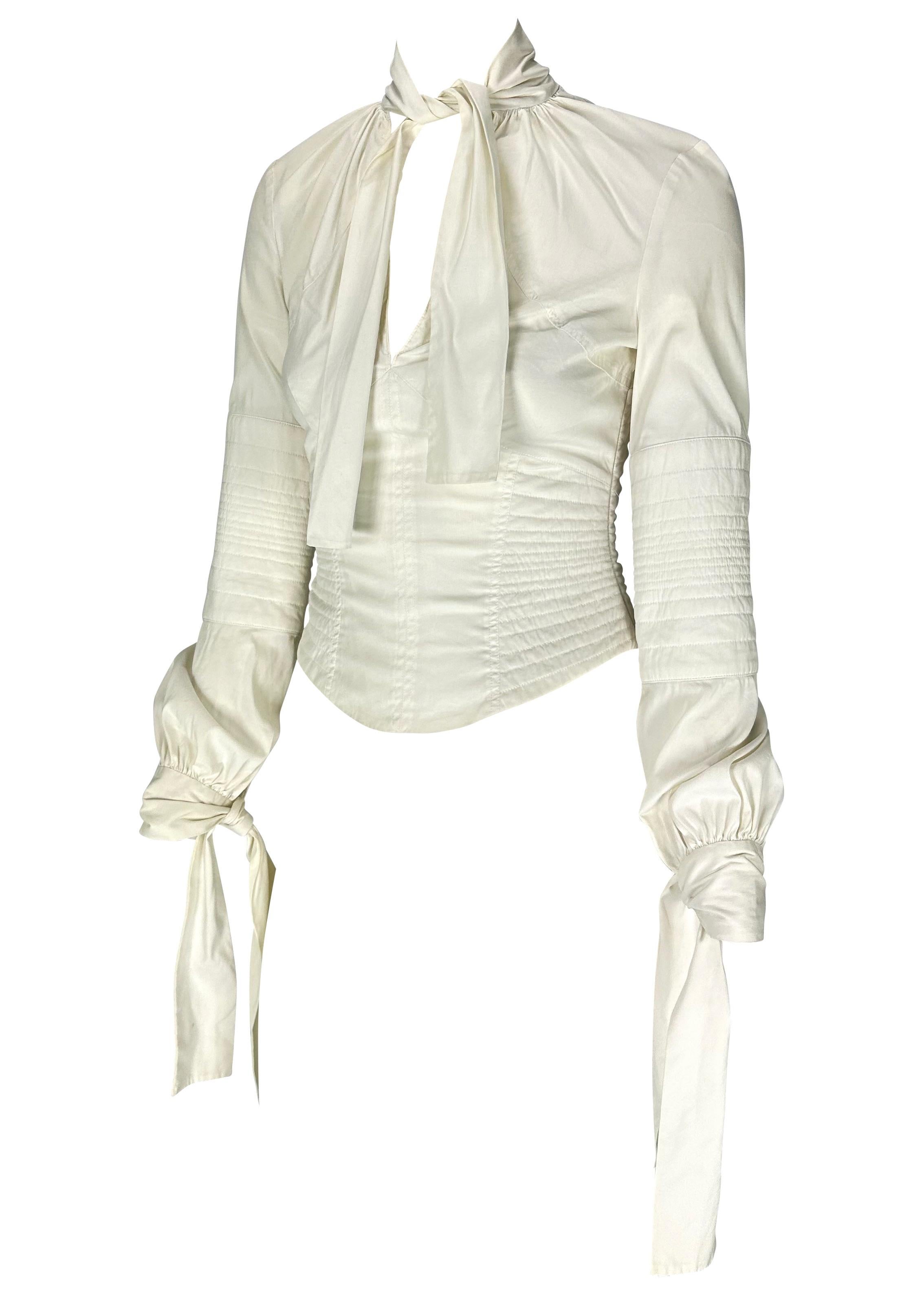 Presenting a white cotton Gucci blouse designed by Tom Ford. From the Fall/Winter 2003 collection, this beautiful top features quilted details on the body creating a corset silhouette. With a deep neckline, this top has ties that wrap around the