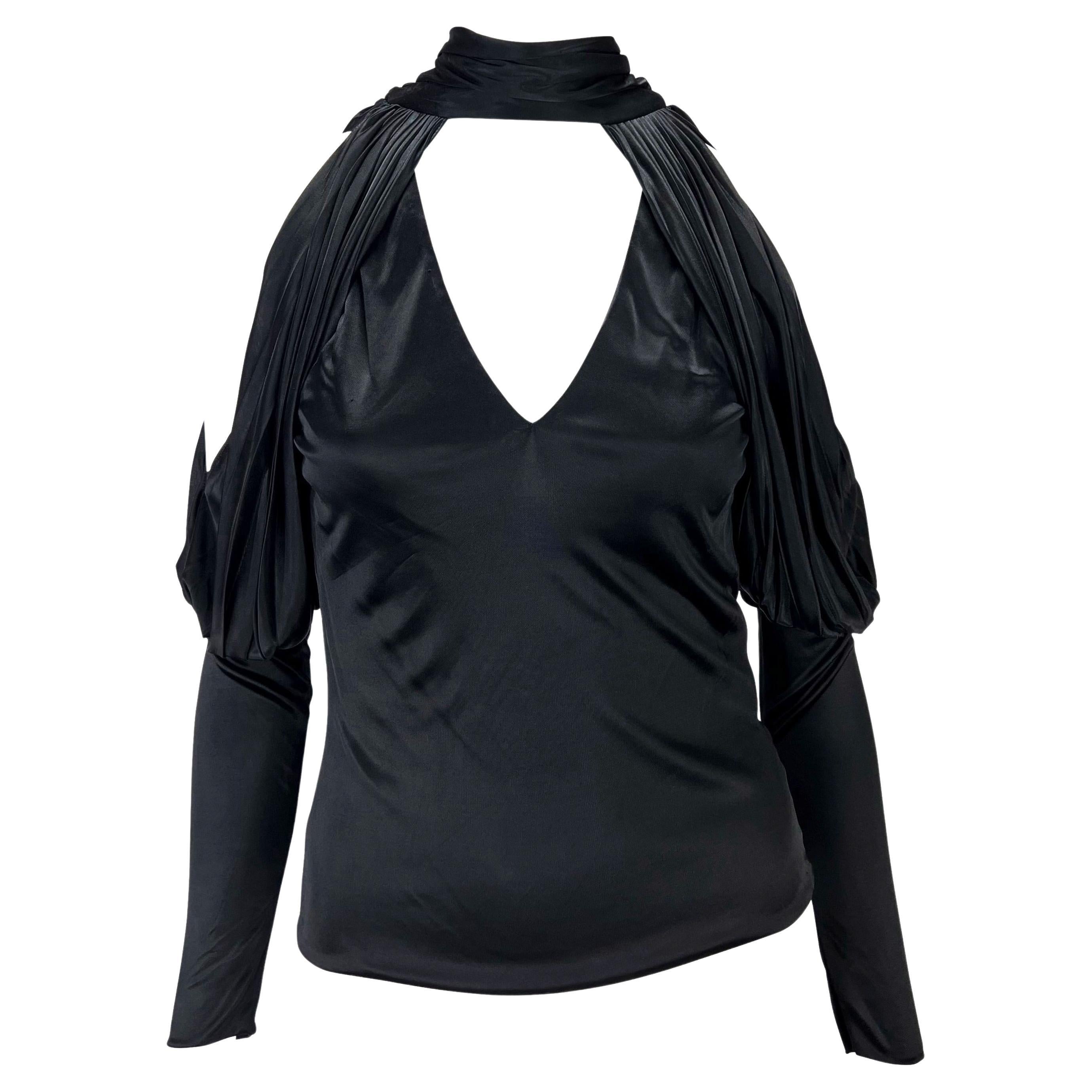 TheRealList presents: an incredible silky viscose black Gucci top, designed by Tom Ford. From the Fall/Winter 2003 collection, this ultra sexy top features a deep v-neckline, exposed back, and exposed shoulders. This rare and masterfully designed