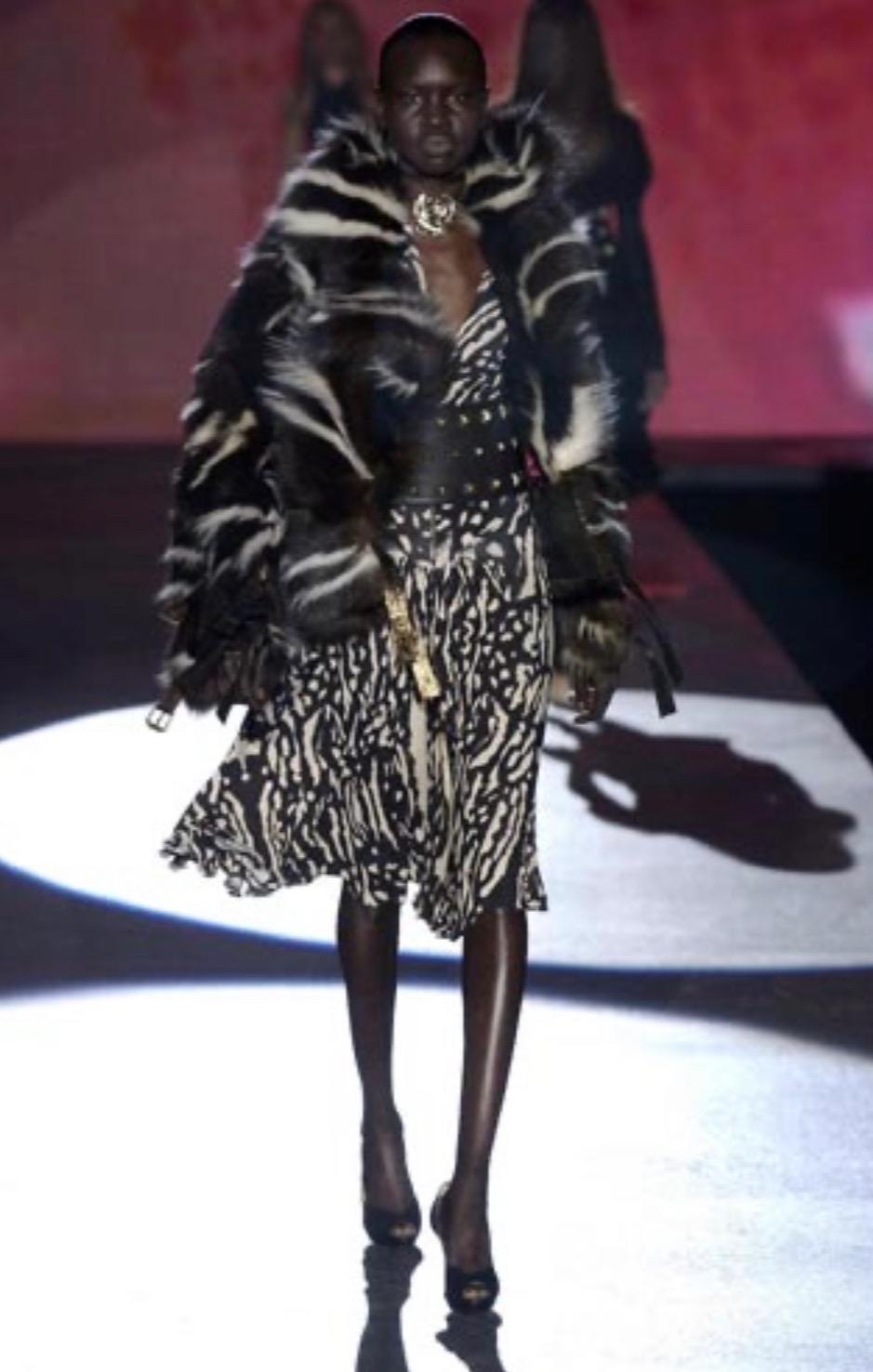 Presenting an animal print corseted mini dress designed by Roberto Cavalli for his Fall/Winter 2003 collection. This figure-hugging stretch dress debuted on the season's runway with a longer skirt on look 50 on Alek Wek and was also highlighted in
