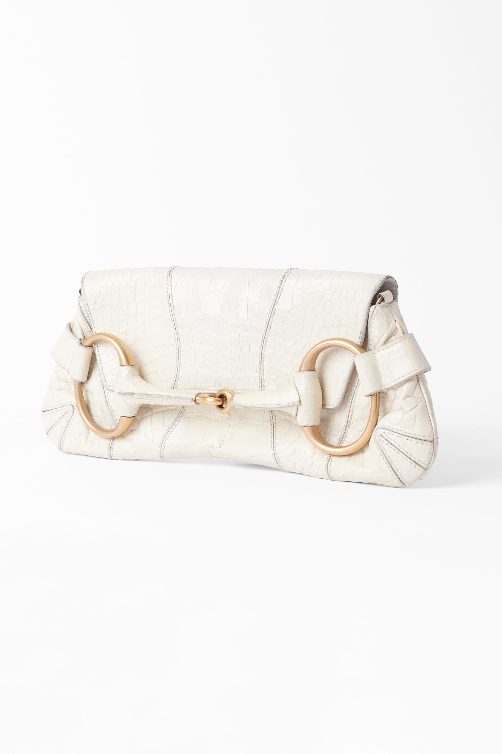 We are excited to present this incredibly iconic Tom Ford for Gucci Fall Winter 2003 cream crocodile clutch. As seen on the runway, look 11 & 40 - collectors item. Features signature horsebit detailing, crocodile leather skin, detachable chain strap