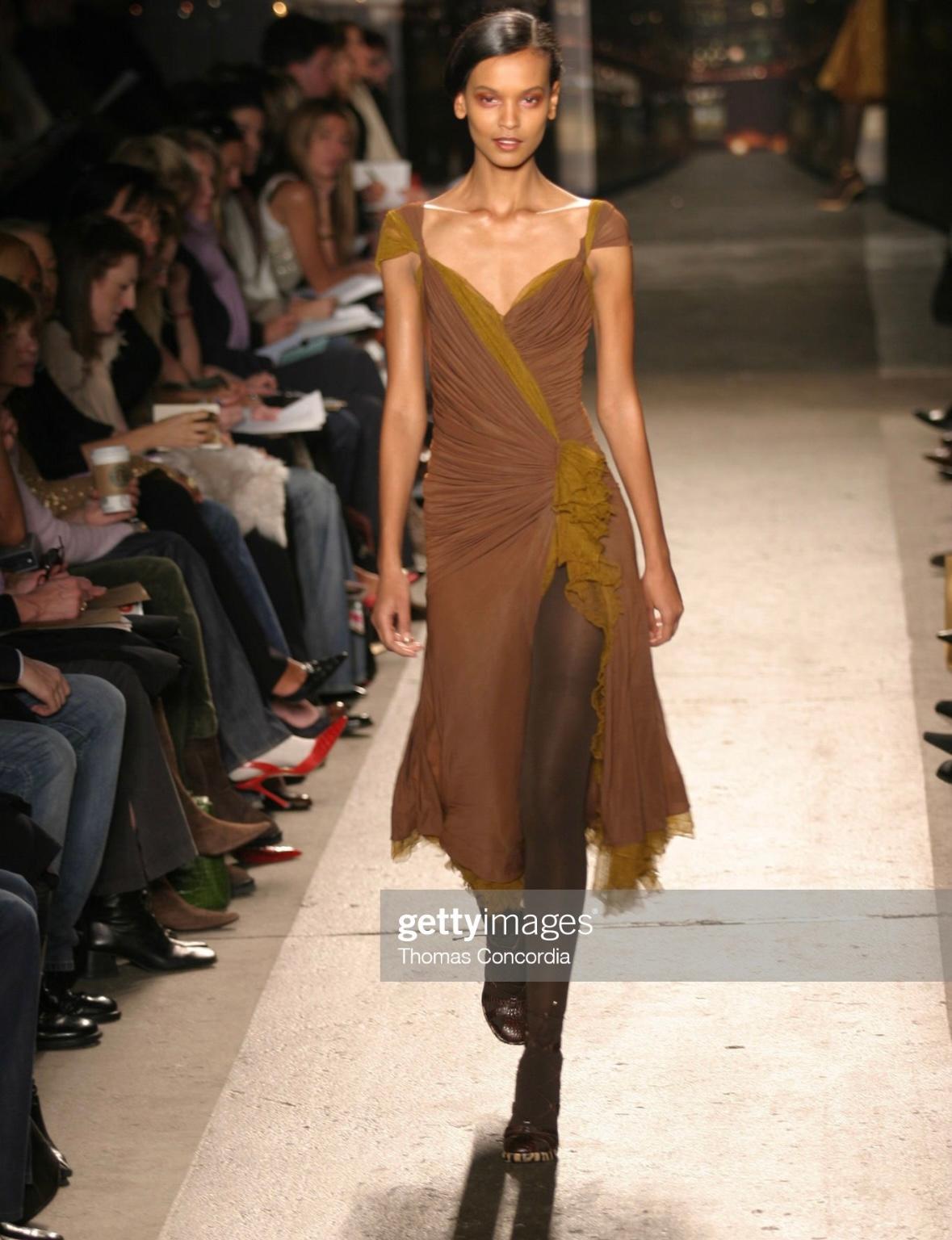Presenting a brown ruched Donna Karan dress. From the Fall/Winter 2004 collection, a version of this dress debuted on the season’s runway as look 37 modeled by Liya Kebede. This chocolate brown dress features a flared skirt, ruching throughout, and