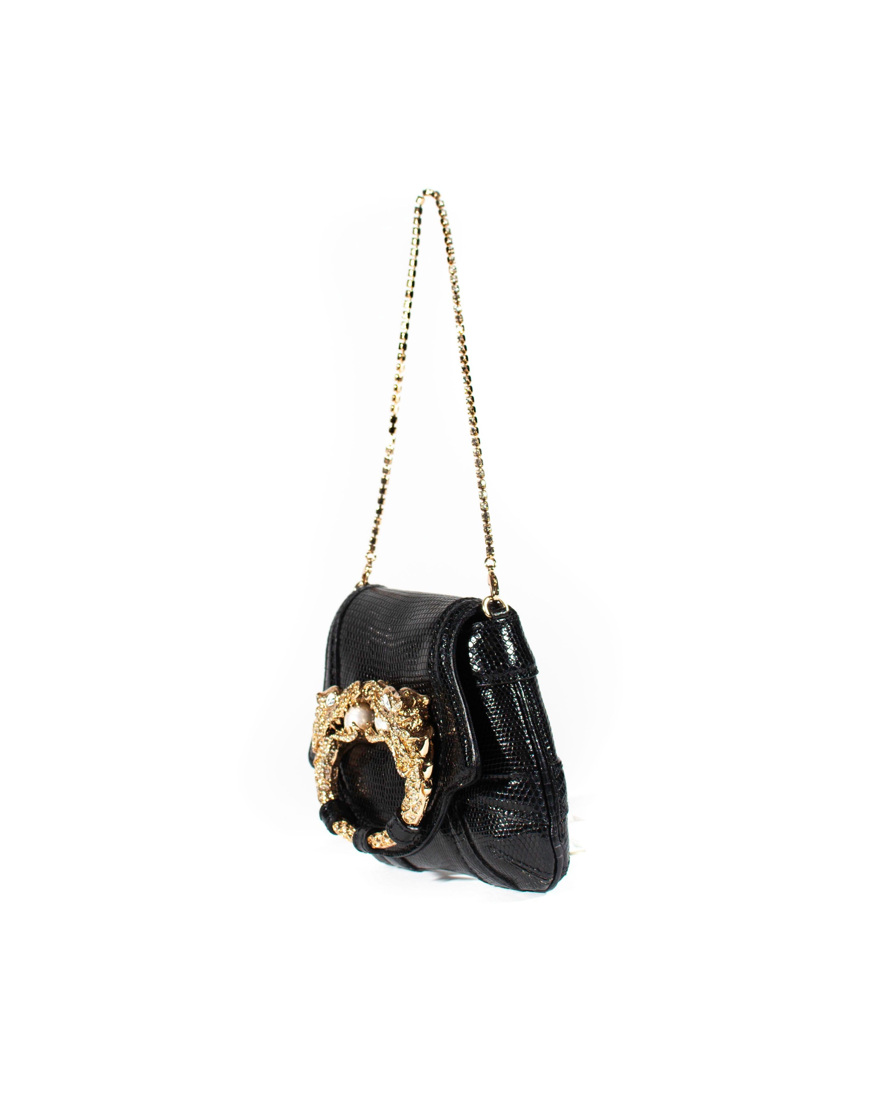 TheRealList presents: a fabulous black lizard skin mini F/W 2004 Gucci bag with a dragon accent, designed by Tom Ford. This petite bag can be used as a mini bag or as a clutch when the rhinestone chain handle is removed. The bag was debuted on the