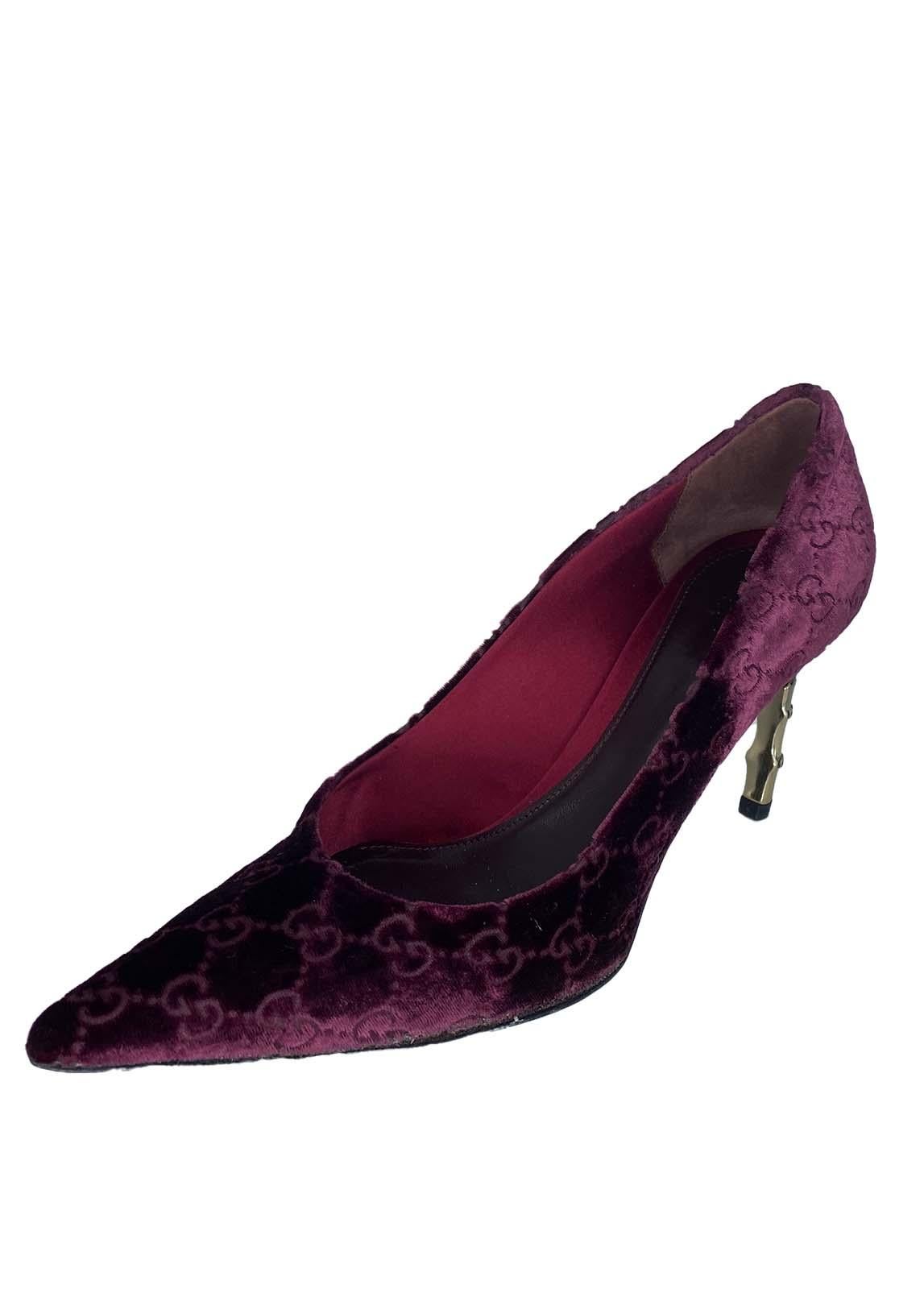 TheRealList presents: a pair incredible burgundy velvet 'GG' Gucci Shoes, designed by Tom Ford. These shoes were designed for the F/W 2004 collection, which was Tom Ford's last at Gucci. The heels are constructed of a small metal bamboo piece with a