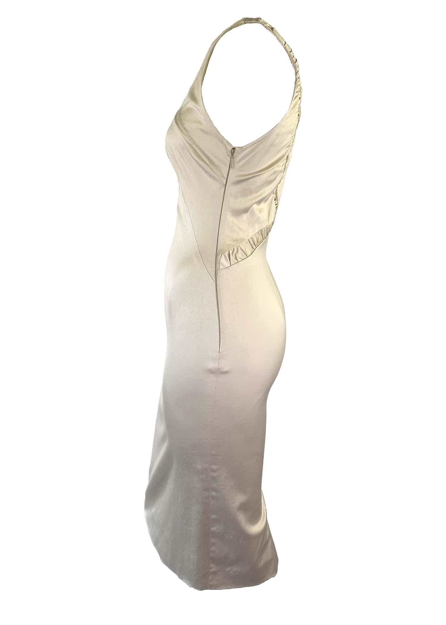 Presenting a stunning creme color sleeveless Gucci dress, designed by Tom Ford. This new with tags dress is from the Fall/Winter 2004 collection and features a peekaboo opening at the bust with ruched accents and skirt slit at the back. This