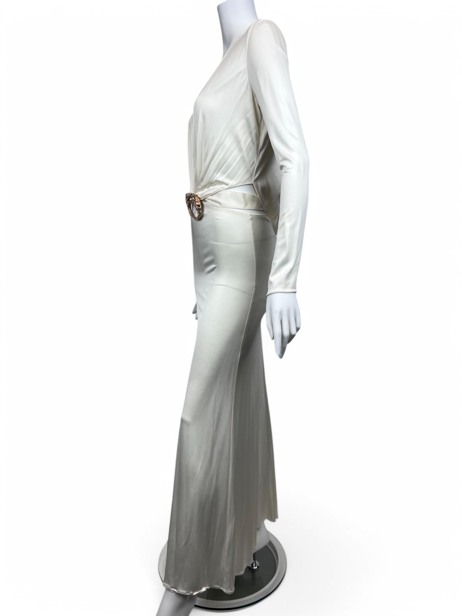 A rare and striking piece from Tom Ford’s Fall/Winter 2004 collection for Gucci, this white cut-out dragon gown epitomizes bold sensuality and high-fashion drama. The sleek, figure-hugging silhouette is accentuated by strategic cut-outs that create