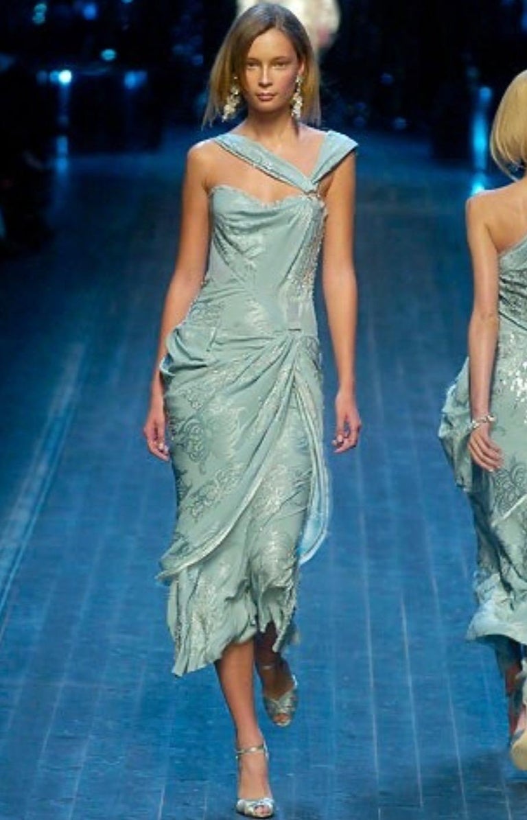 TheRealList presents: a sensual light blue Christian Dior gown, designed by John Galliano. From the Fall/Winter collection, a similar dress debuted as look number 46 on the season's runway, modeled by Tiiu Kuik. Galliano masterfully designed this